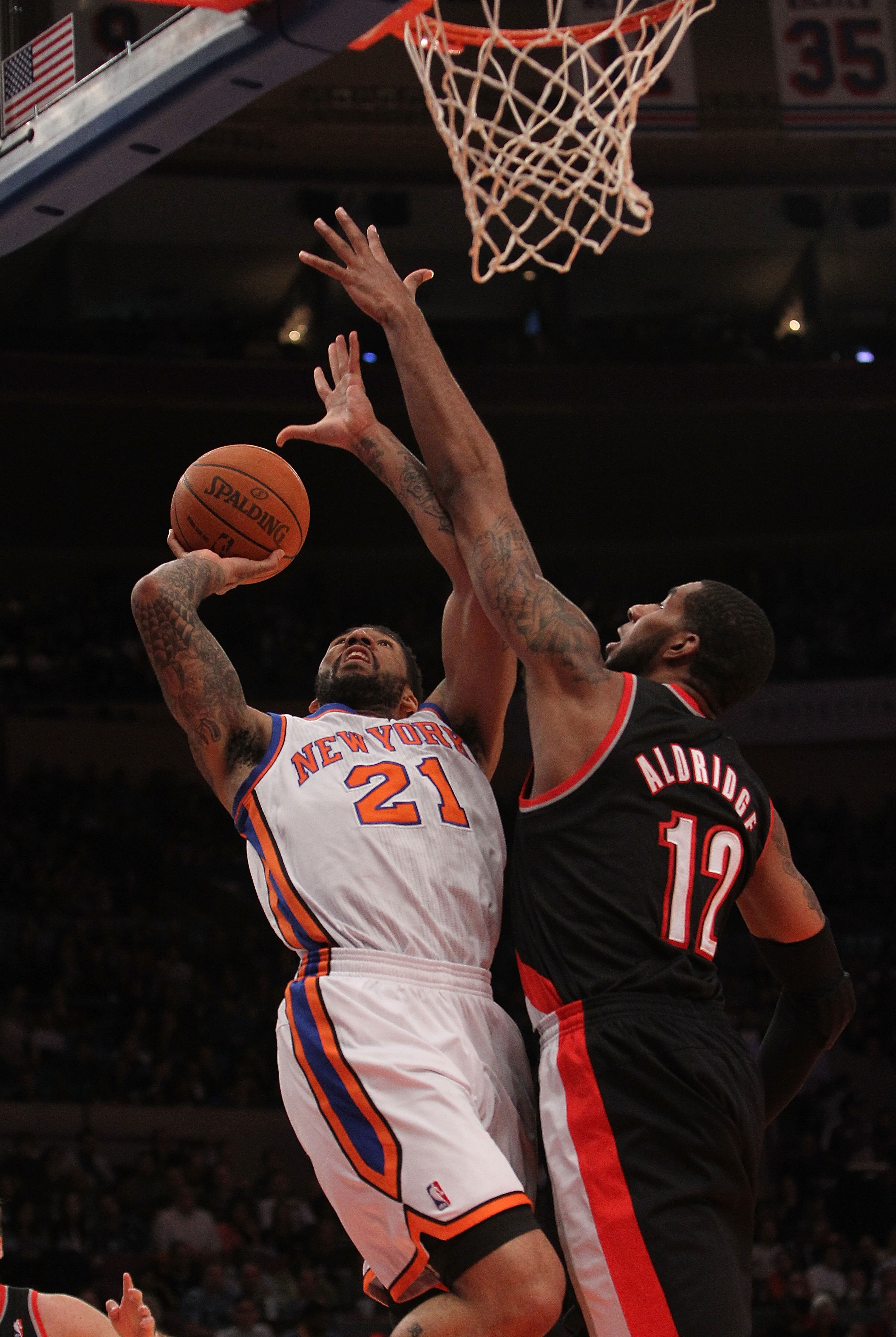 NEW YORK - OCTOBER 30: Wilson Chandler #21 of the New York Knicks shoots the ball against LaMarcus Aldridge #12 of the Portland Trail Blazers at Madison Square Garden on October 30, 2010 in New York City. NOTE TO USER: User expressly acknowledges and agre