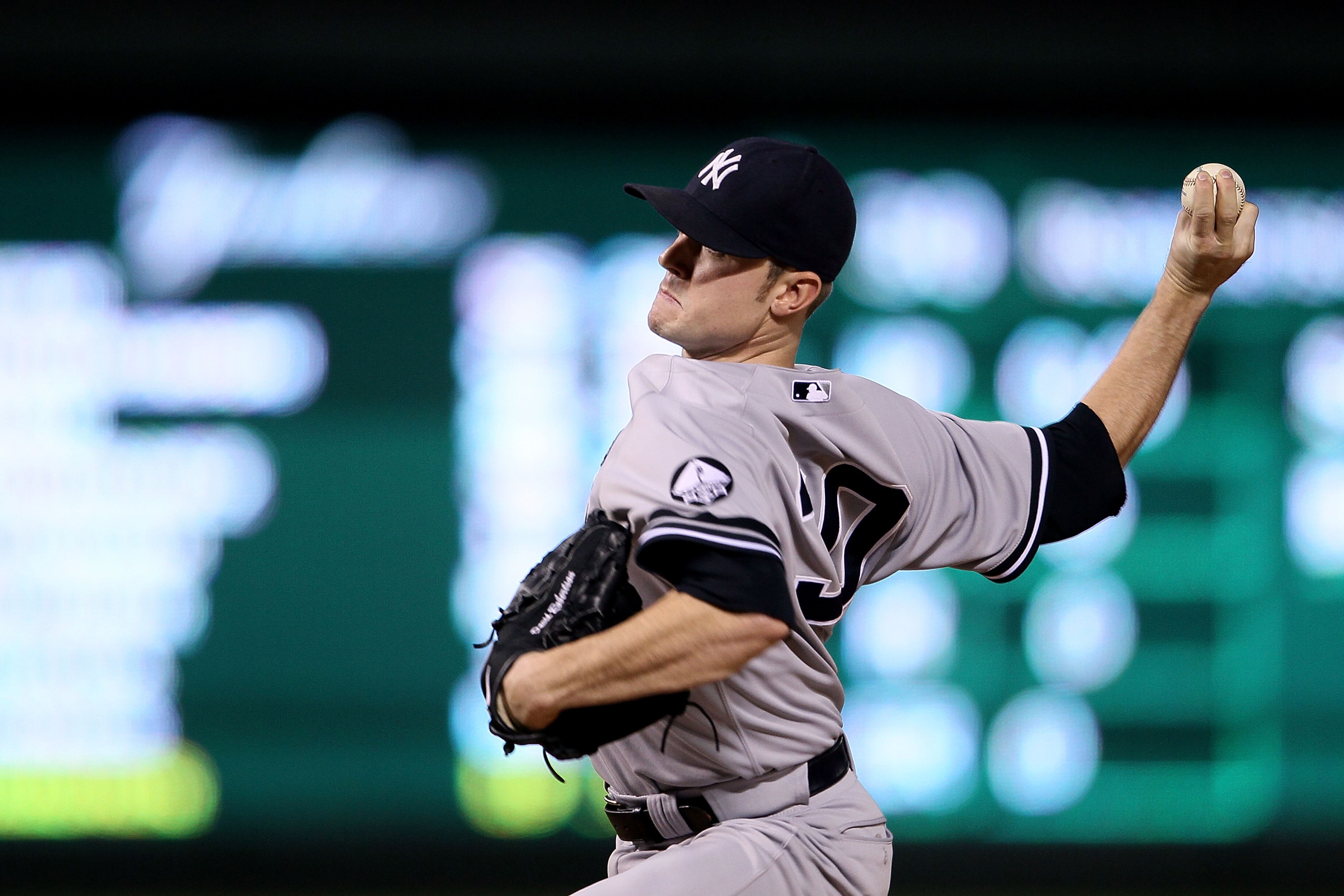 ARLINGTON, TX - OCTOBER 22:  David Robertson #30 of the New York Yankees throws a pitch against the Texas Rangers in Game Six of the ALCS during the 2010 MLB Playoffs at Rangers Ballpark in Arlington on October 22, 2010 in Arlington, Texas. The Rangers wo