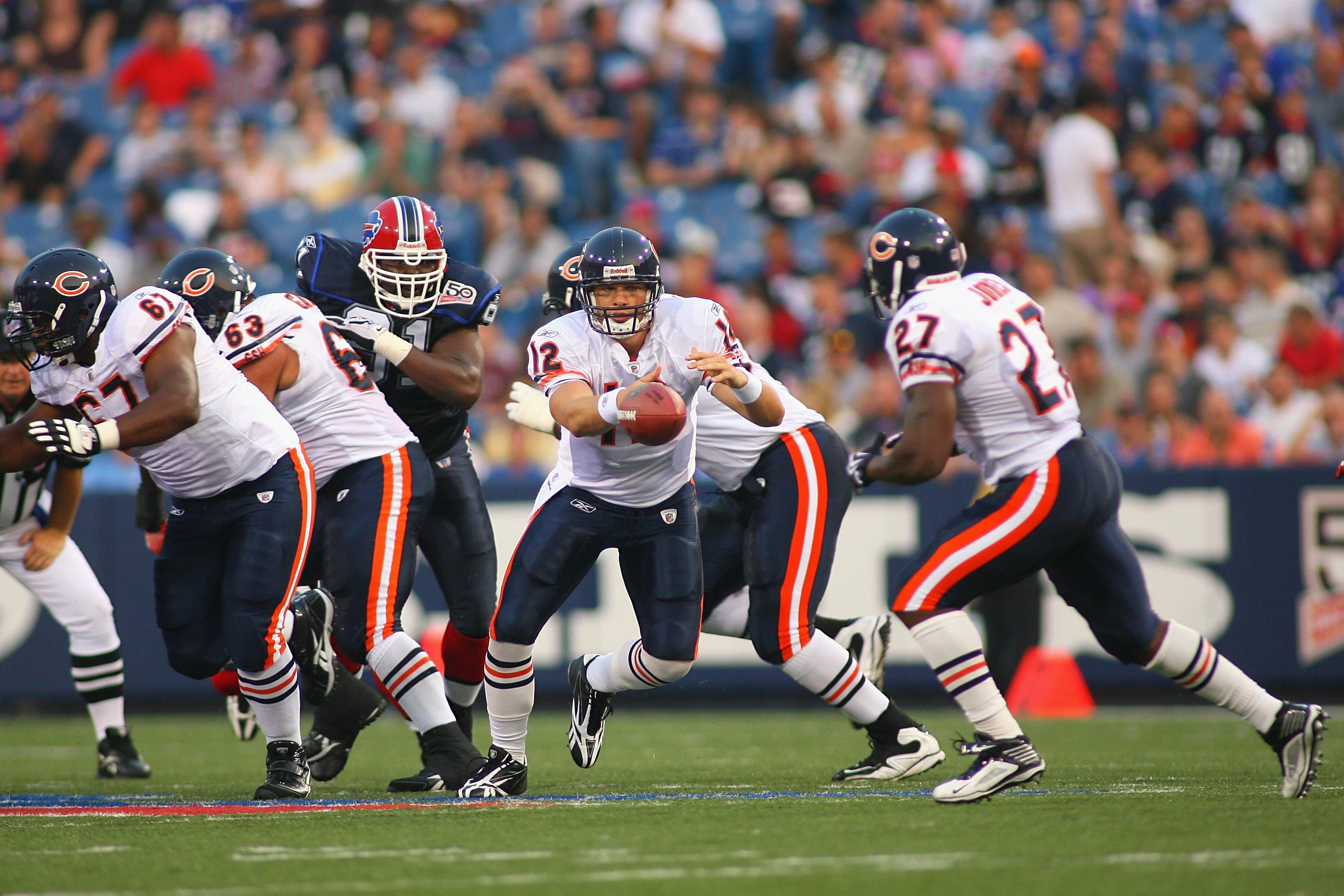 ORCHARD PARK, NY - AUGUST 15:  Quarterback Caleb Hanie #12 of the Chicago Bears hands off to running back Kevin Jones #27 during the preseason game against the Buffalo Bills on August 15, 2009 at Ralph Wilson Stadium in Orchard Park, New York. The Bills w