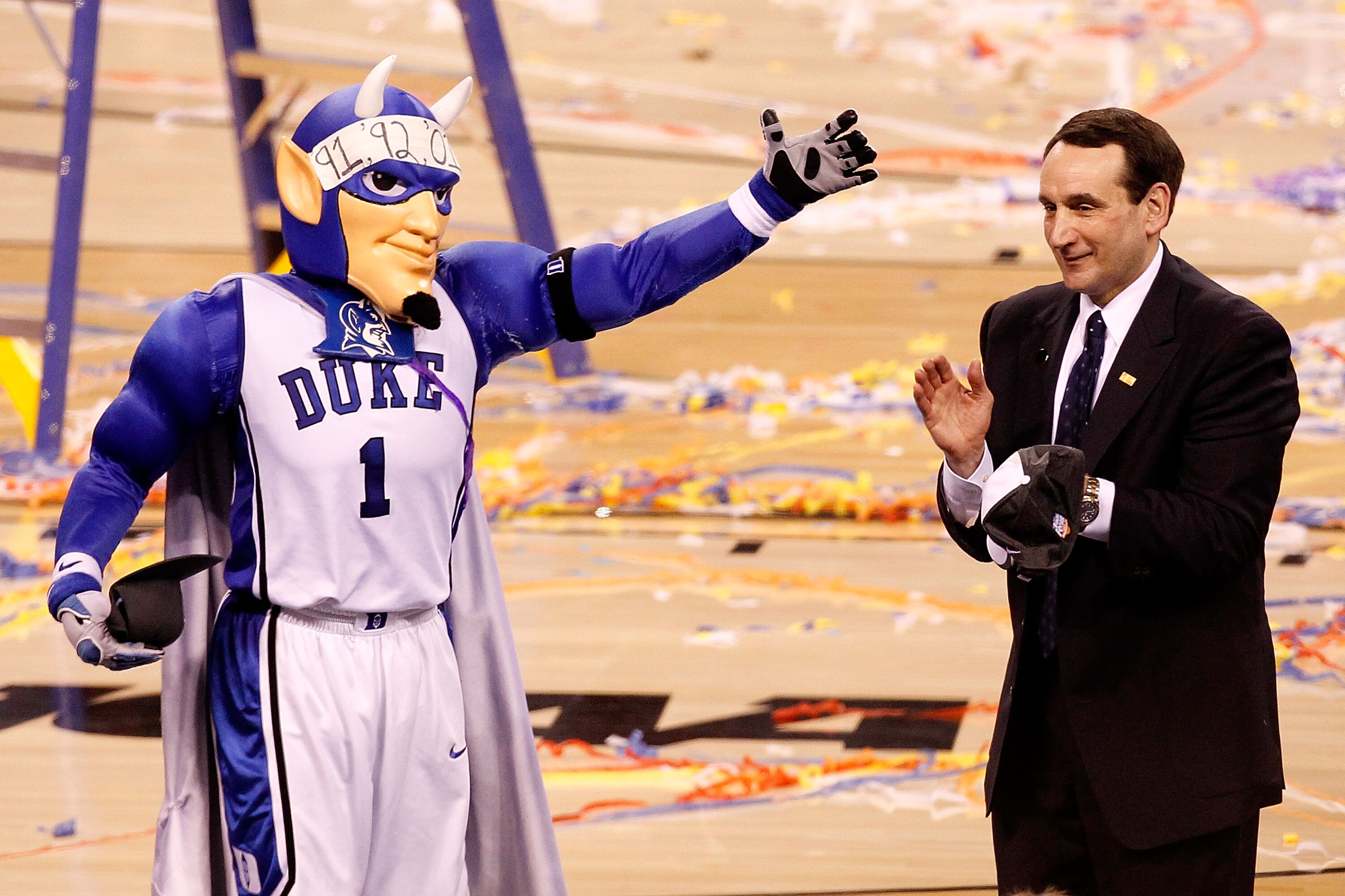 INDIANAPOLIS - APRIL 05:  The mascot and head coach Mike Krzyzewski of the Duke Blue Devils celebrate on court after they won 61-59 against the Butler Bulldogs during the 2010 NCAA Division I Men's Basketball National Championship game at Lucas Oil Stadiu