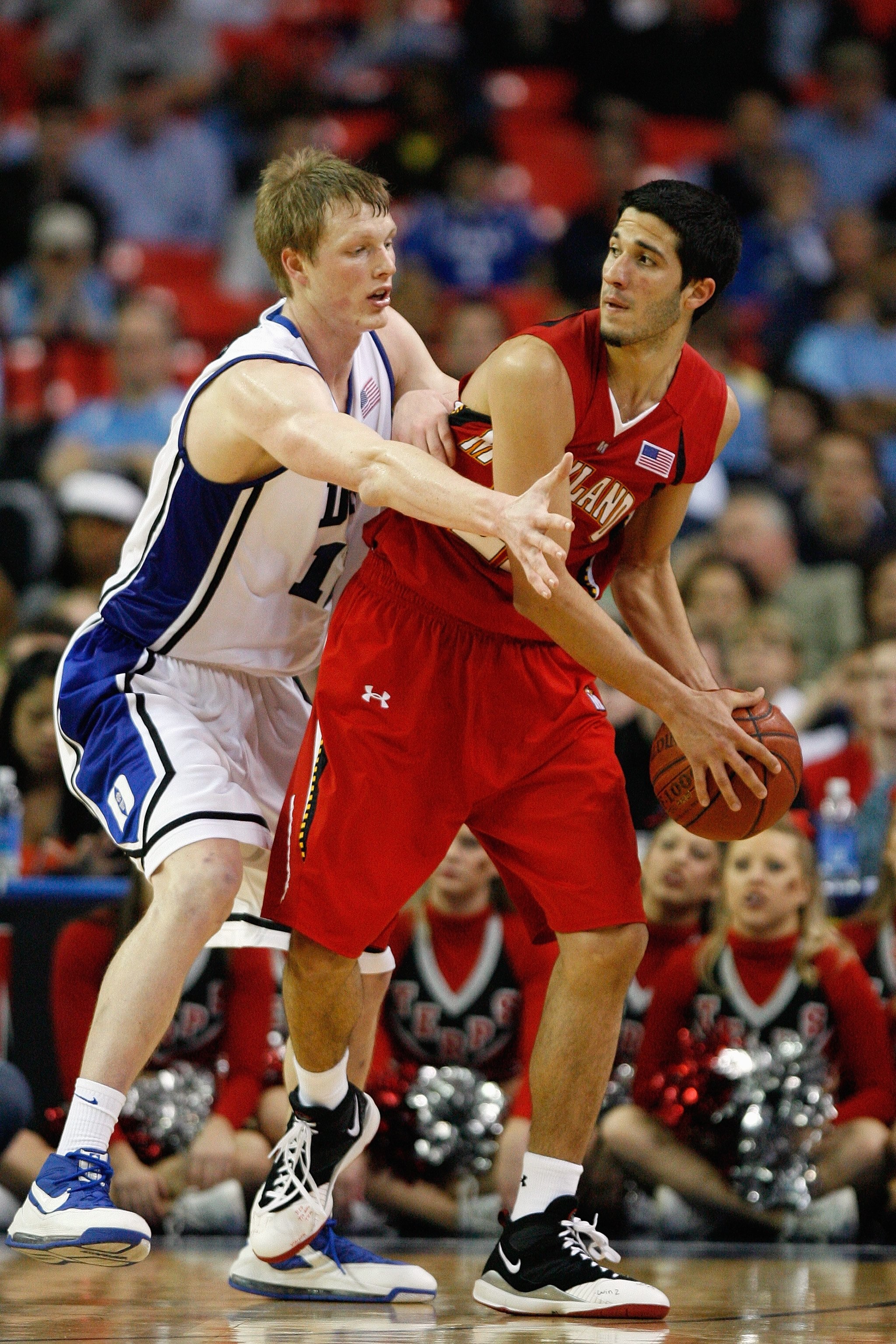ATLANTA - MARCH 14:  Kyle Singler #12 of the Duke Blue Devils defends against Greivis Vasquez #21 of the Maryland Terrapins during the semifinals of the 2009 ACC Men's Basketball Tournament on March 14, 2009 at the Georgia Dome in Atlanta, Georgia.  (Phot