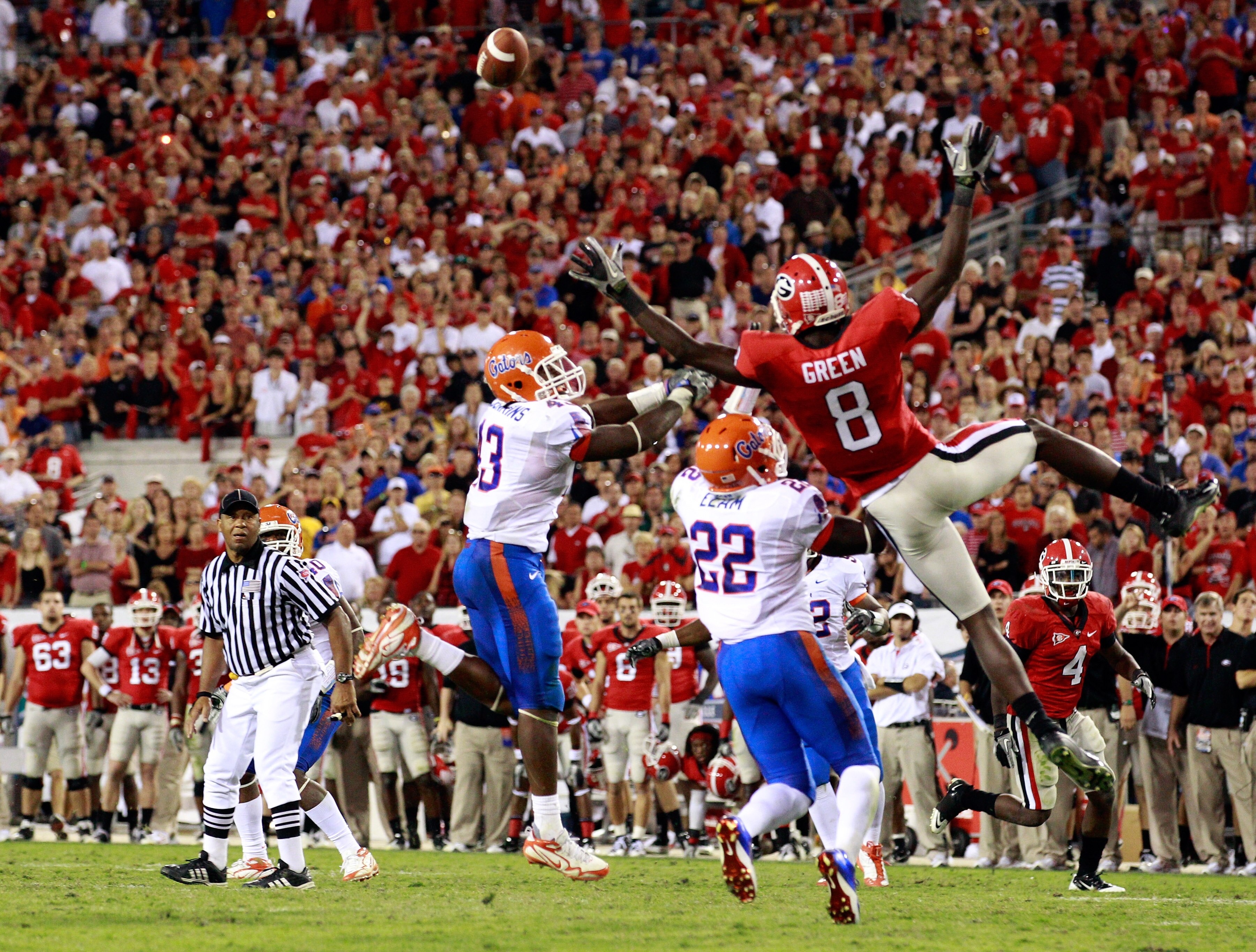 JACKSONVILLE, FL - OCTOBER 30:  A.J. Green #8 of the Georgia Bulldogs attempts to catch a pass against Jelani Jenkins #43 and Matt Elam #22 of the Florida Gators during the game at EverBank Field on October 30, 2010 in Jacksonville, Florida.  (Photo by Sa