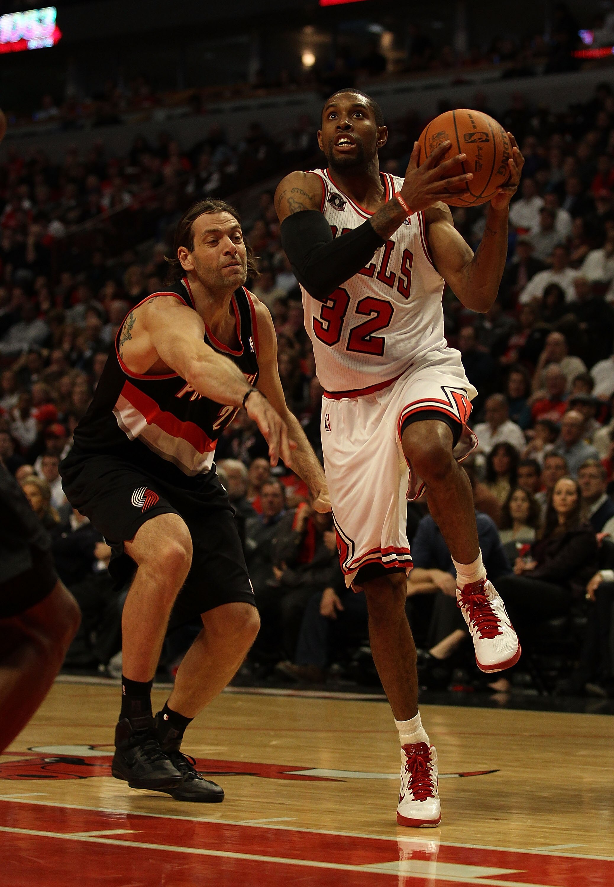 CHICAGO - NOVEMBER 01: C.J. Watson #32 of the Chicago Bulls drives to the basket past Fabricio Oberto #21 of the Portland Trail Blazers at the United Center on November 1, 2010 in Chicago, Illinois. The Bulls defeated the Trail Blazers 110-98. NOTE TO USE