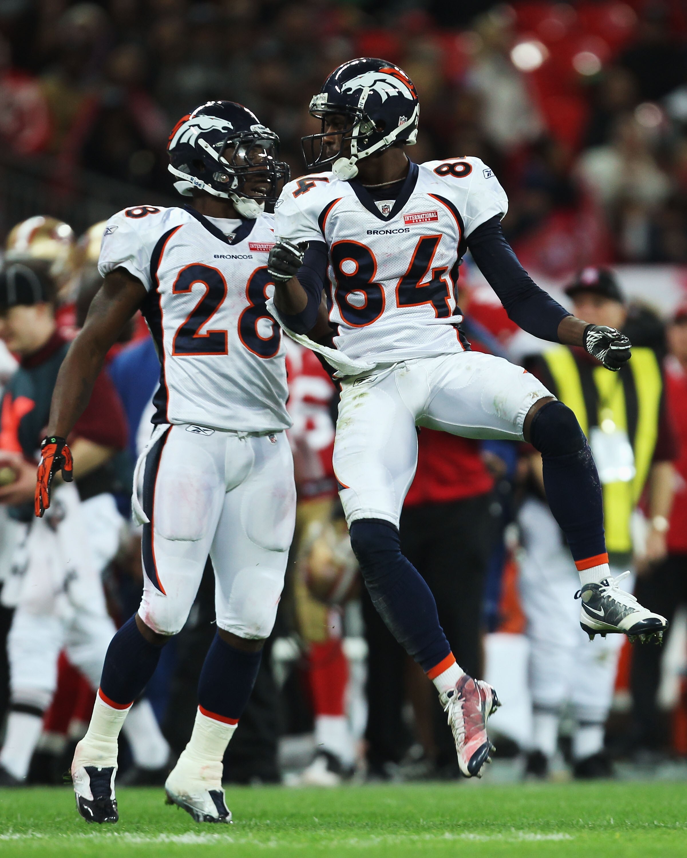 LONDON, ENGLAND - OCTOBER 31:  Brandon Lloyd #84 of Denver Broncos celebrates with Correll Buckhalter #28 of Denver Broncos during the NFL International Series match between Denver Broncos and San Francisco 49ers at Wembley Stadium on October 31, 2010 in