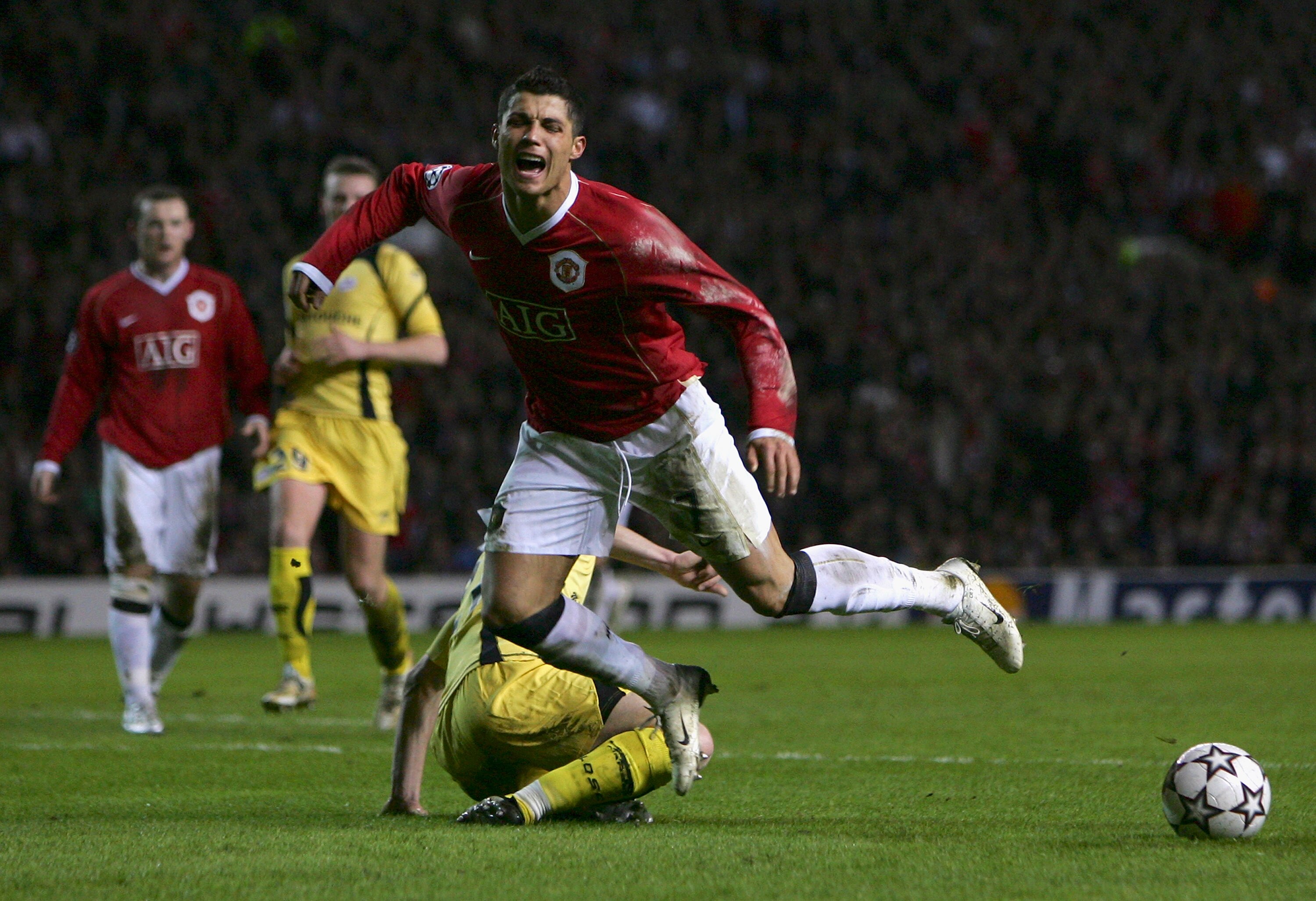 MANCHESTER, UNITED KINGDOM - MARCH 07:  Cristiano Ronaldo of Manchester United falls dramatically after being challenged by Matthieu Chalme of Lille, and is subsequently booked for diving during the UEFA Champions League round of sixteen, second leg match