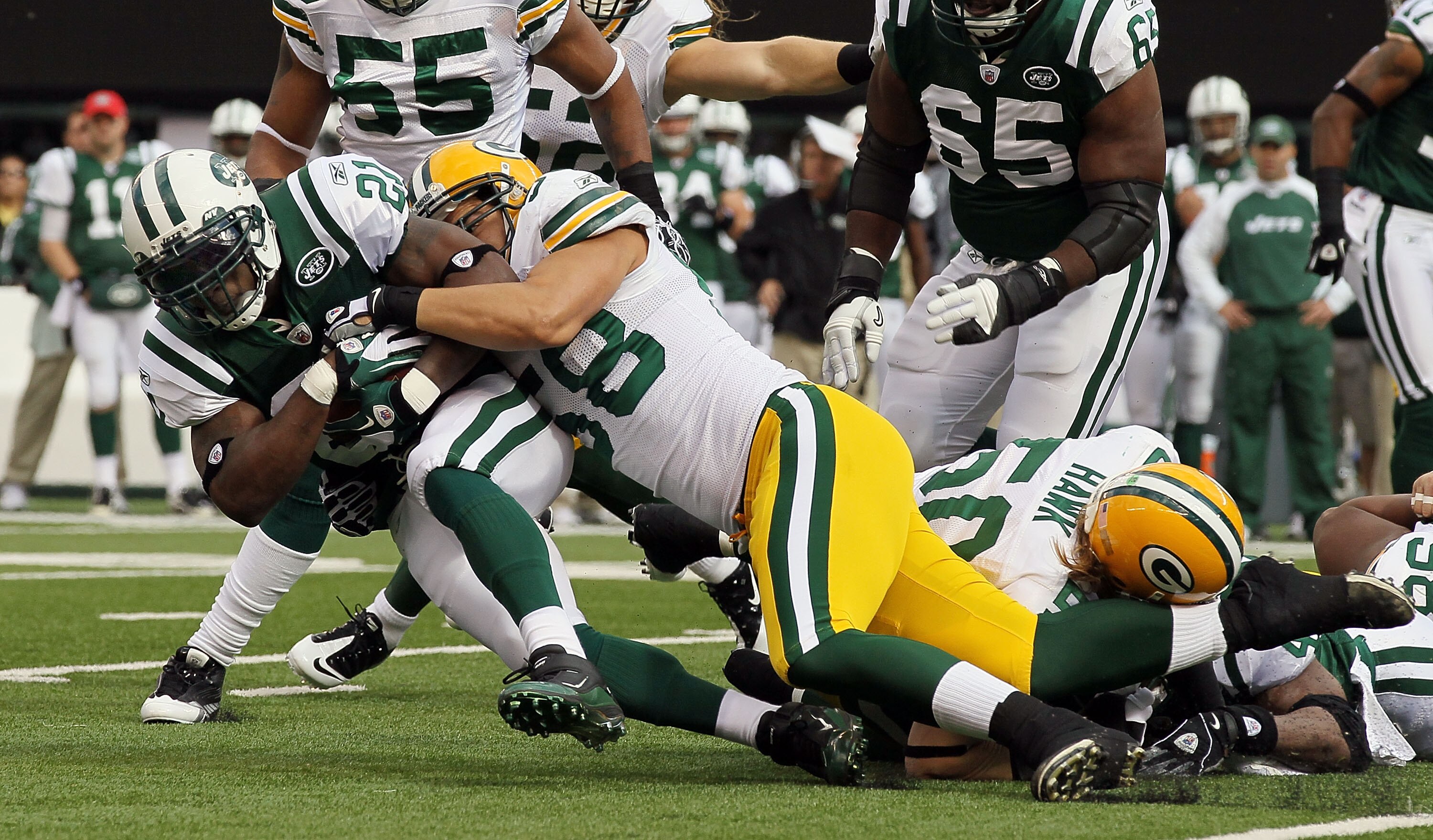 EAST RUTHERFORD, NJ - OCTOBER 31:  LaDainian Tomlinson #21 of the New York Jets is tackled by C.J. Wilson #98 of the Green Bay Packers on October 31, 2010 at the New Meadowlands Stadium in East Rutherford, New Jersey.  (Photo by Jim McIsaac/Getty Images)