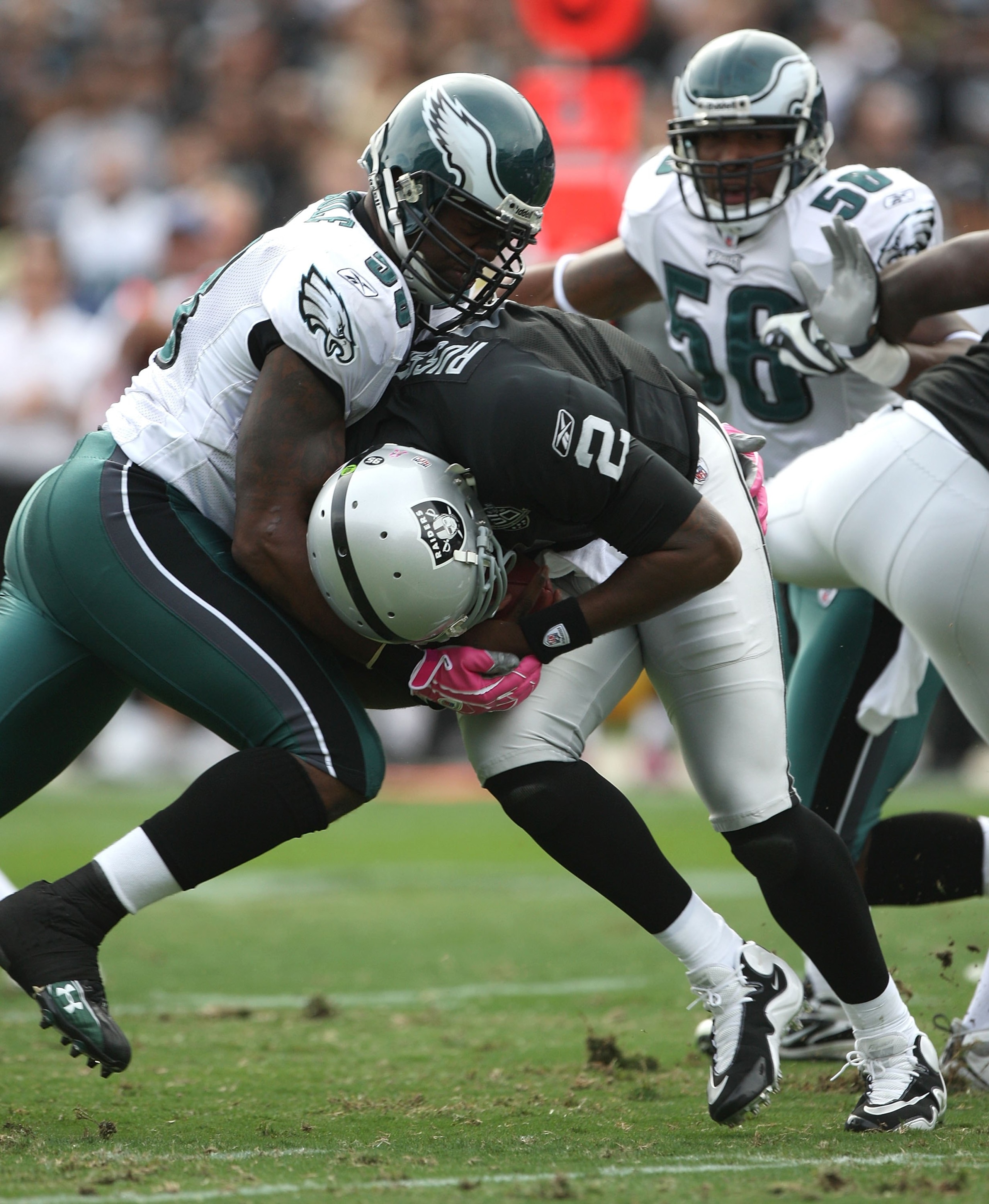 OAKLAND, CA - OCTOBER 18:  JaMarcus Russell #2 of the Oakland Raiders is sacked by Trent Cole #58 of the Philadelphia Eagles during an NFL game at the Oakland-Alameda County Coliseum on October 18, 2009 in Oakland, California.  (Photo by Jed Jacobsohn/Get