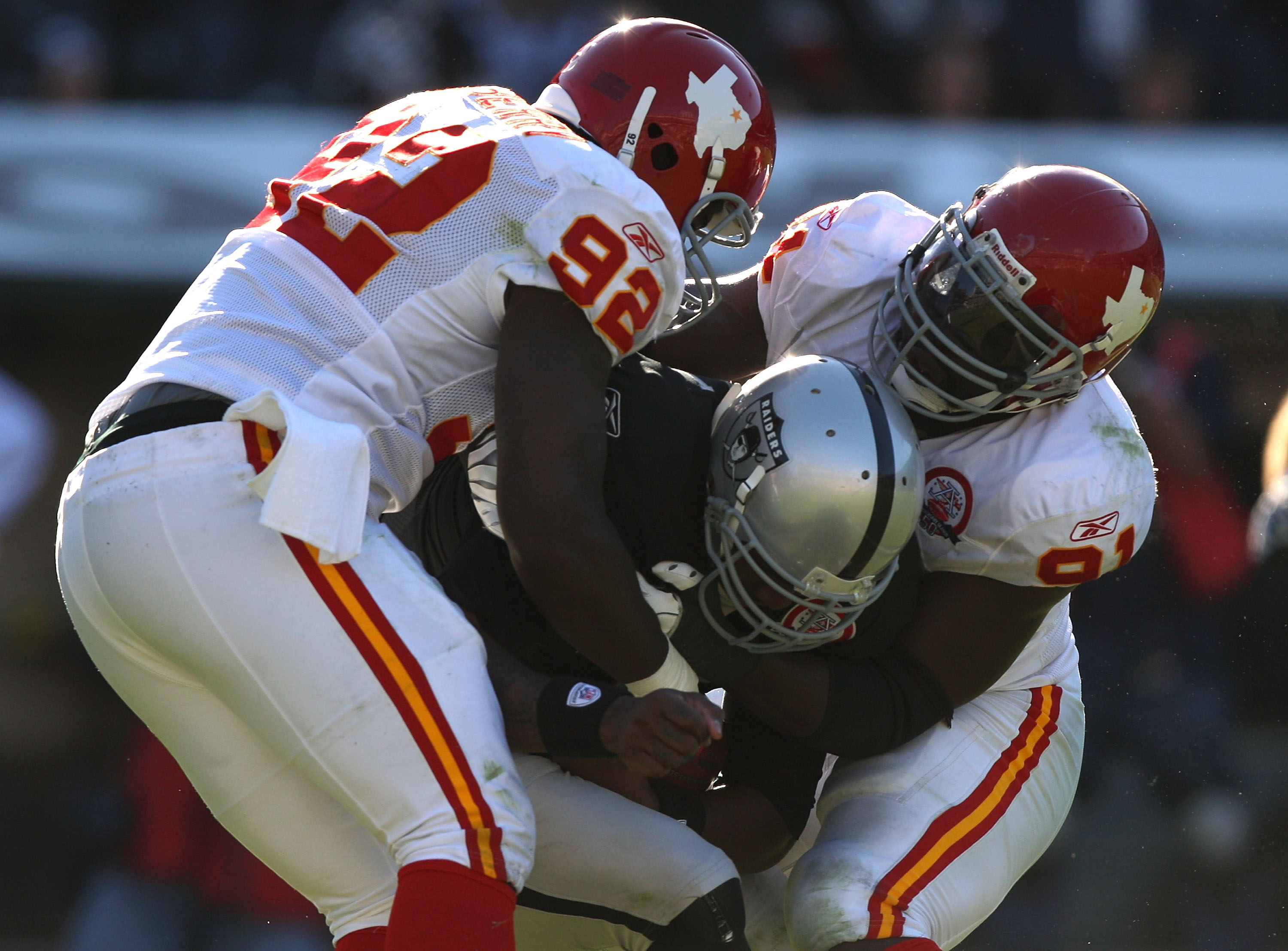 OAKLAND, CA - NOVEMBER 15: Wallace Gilberry #92 and Tamba Hali #91 of the Kansas City Chiefs sack JaMarcus Russell #2 of the Oakland Raiders during an NFL game  at Oakland-Alameda County Coliseum on November 15, 2009 in Oakland, California. (Photo by Jed 