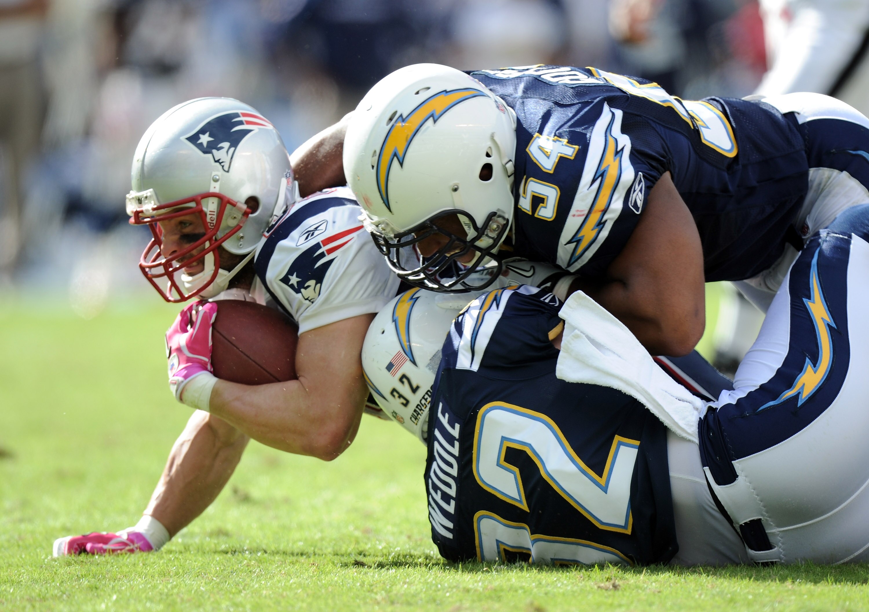 SAN DIEGO - OCTOBER 24:  Wes Welker #83 of the New England Patriots is hit after his catch by Stephen Cooper #54 and Eric Weddle #32 of the San Diego Chargers during the second quarter at Qualcomm Stadium on October 24, 2010 in San Diego, California.  (Ph