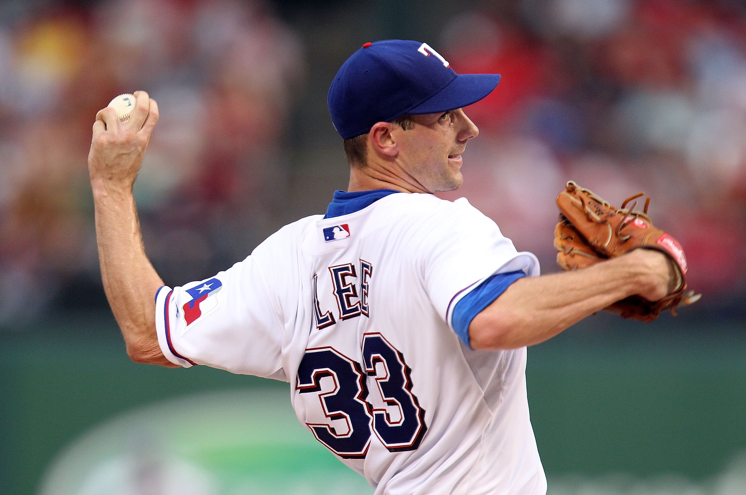 ARLINGTON, TX - JULY 10:  Pitcher Cliff Lee #33 of the Texas Rangers throws against the Baltimore Orioles on July 10, 2010 at Rangers Ballpark in Arlington, Texas.  (Photo by Ronald Martinez/Getty Images)