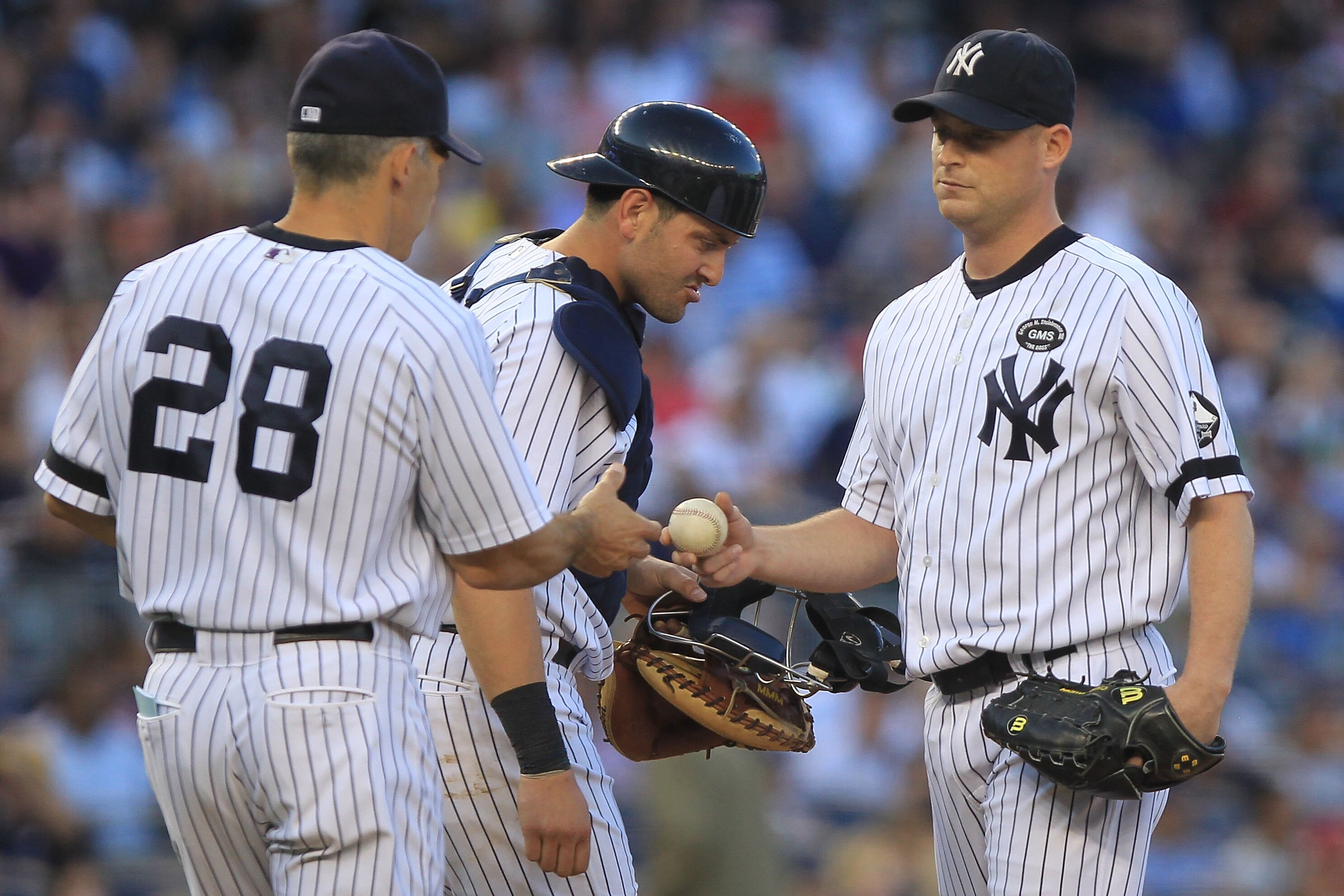NEW YORK - SEPTEMBER 25: Chad Gaudin #41 of the New York Yankees is taken out of the game by manager Joe Girardi #28 against the Boston Red Sox during their game on September 25, 2010 at Yankee Stadium in the Bronx borough of New York City.  (Photo by Chr
