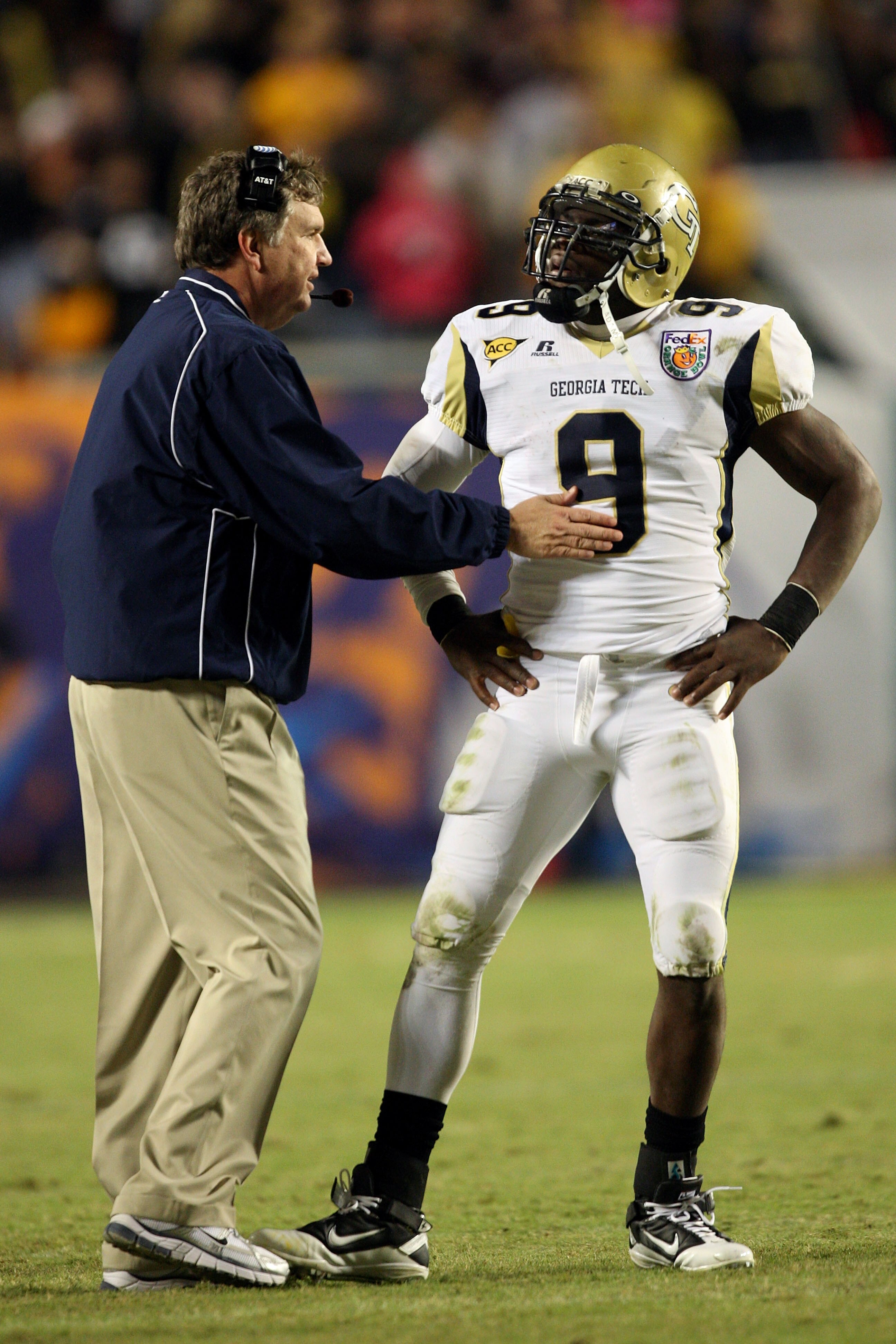 MIAMI GARDENS, FL - JANUARY 05:  Head coach Paul Johnson of the Georgia Tech Yellow Jackets talks with quarterback Josh Nesbitt #9 against the Iowa Hawkeyes during the FedEx Orange Bowl at Land Shark Stadium on January 5, 2010 in Miami Gardens, Florida.