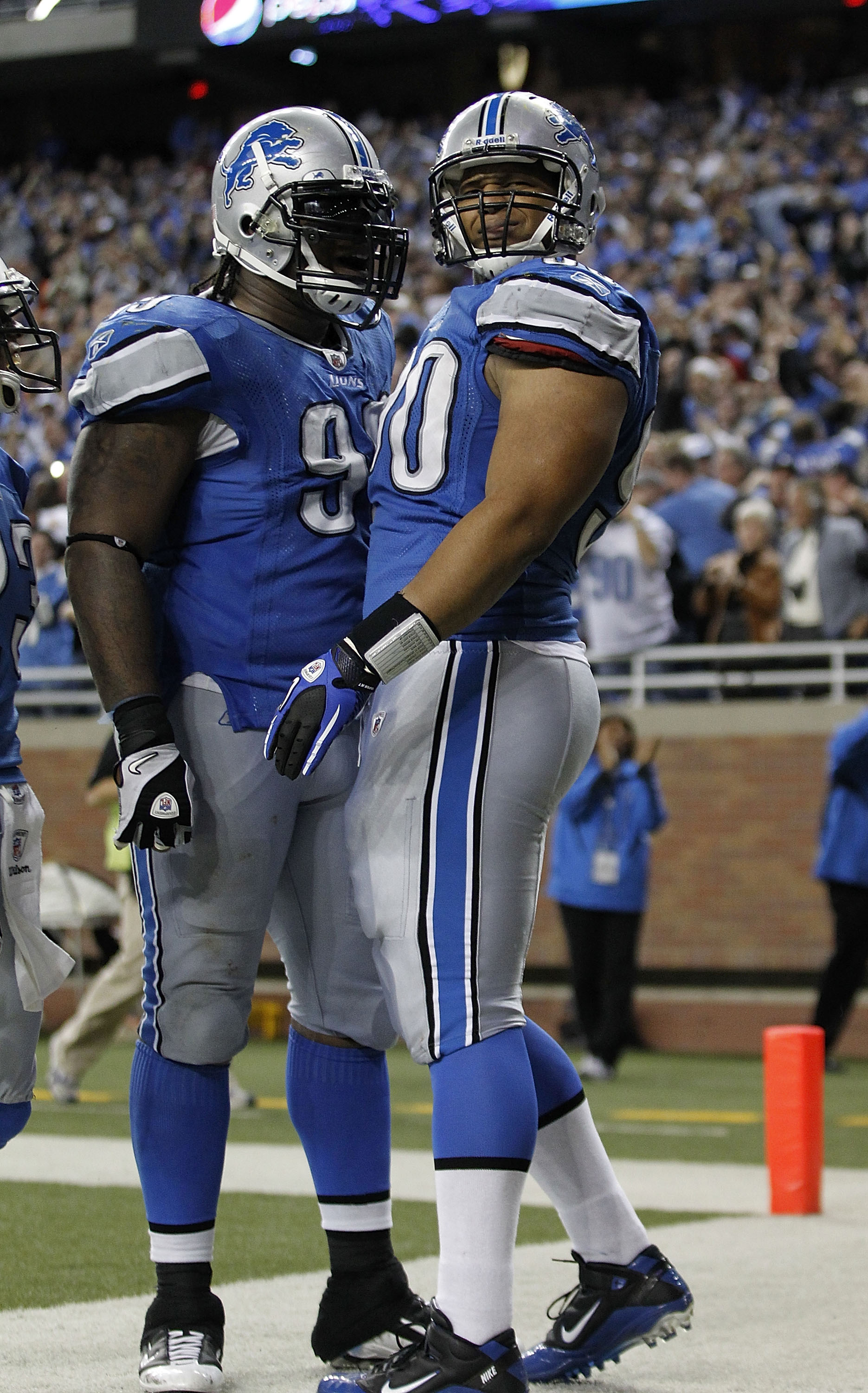 DETROIT - OCTOBER 31: Ndamukong Suh #90 of the Detroit Lions celebrates with teammate Corey Williams #99 after  recovering a late fourth quarter fumble from Rex Grossman #8 of the Washington Redskins an scores a touchdown at Ford Field on October 31, 2010