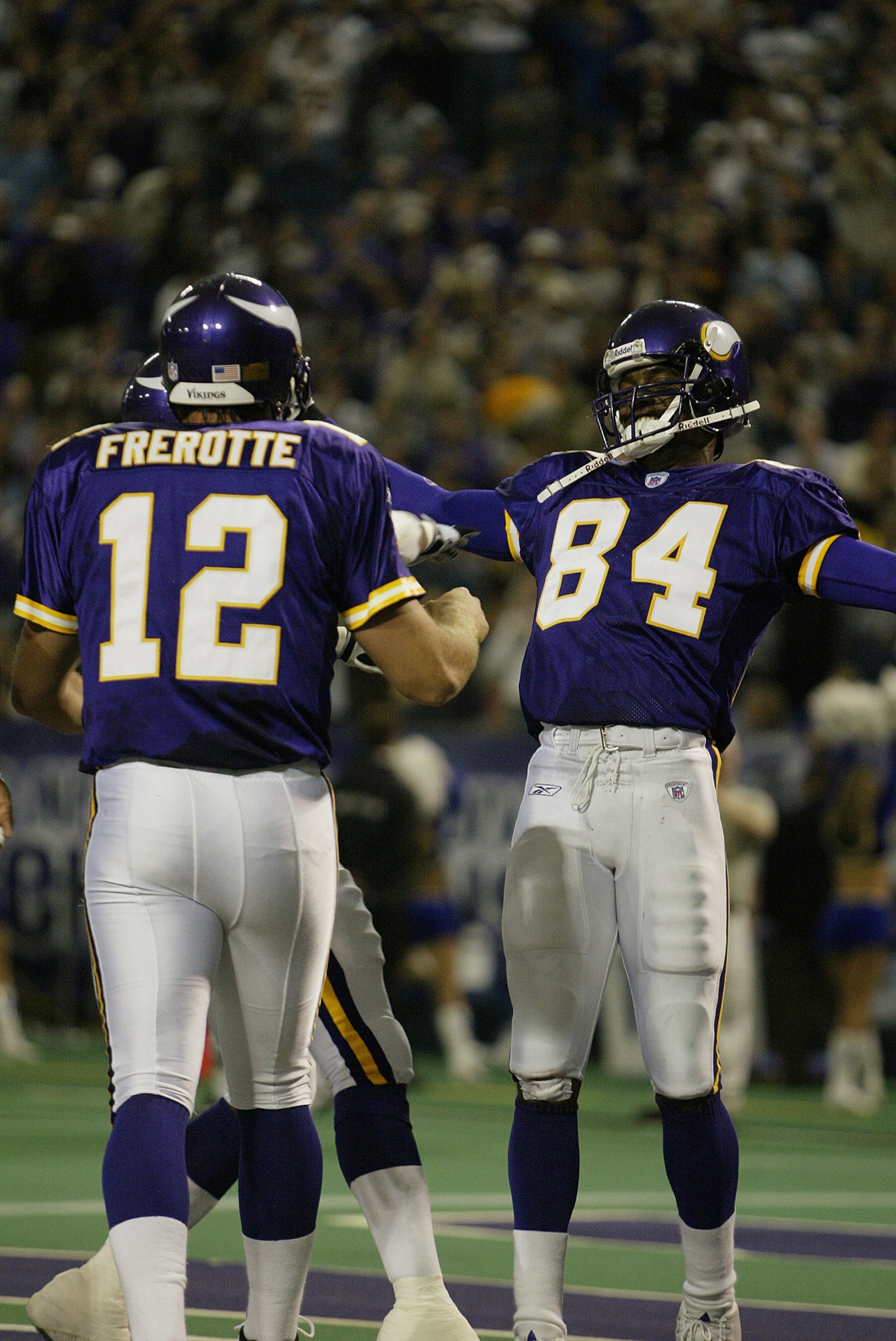 MINNEAPOLIS - SEPTEMBER 28:  Wide receiver Randy Moss #84 and quarterback Gus Frerotte #12 of the Minnesota Vikings celebrate a touchdown in the first half against the San Francisco 49ers at the Hubert H. Humphrey Metrodome on September 28, 2003 in Minnea