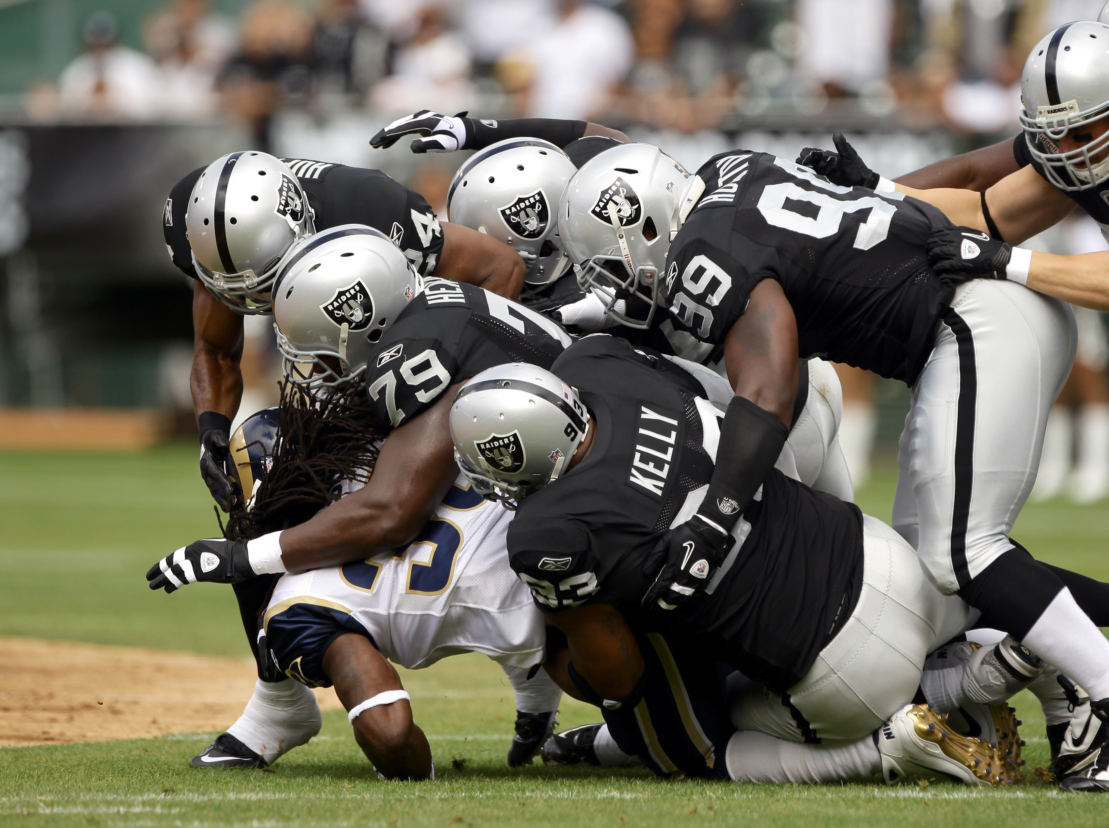 OAKLAND, CA - SEPTEMBER 19:  Steven Jackson #39 of the St. Louis Rams is tackled by the Oakland Raiders defense at the Oakland-Alameda County Coliseum on September 19, 2010 in Oakland, California.  (Photo by Ezra Shaw/Getty Images)