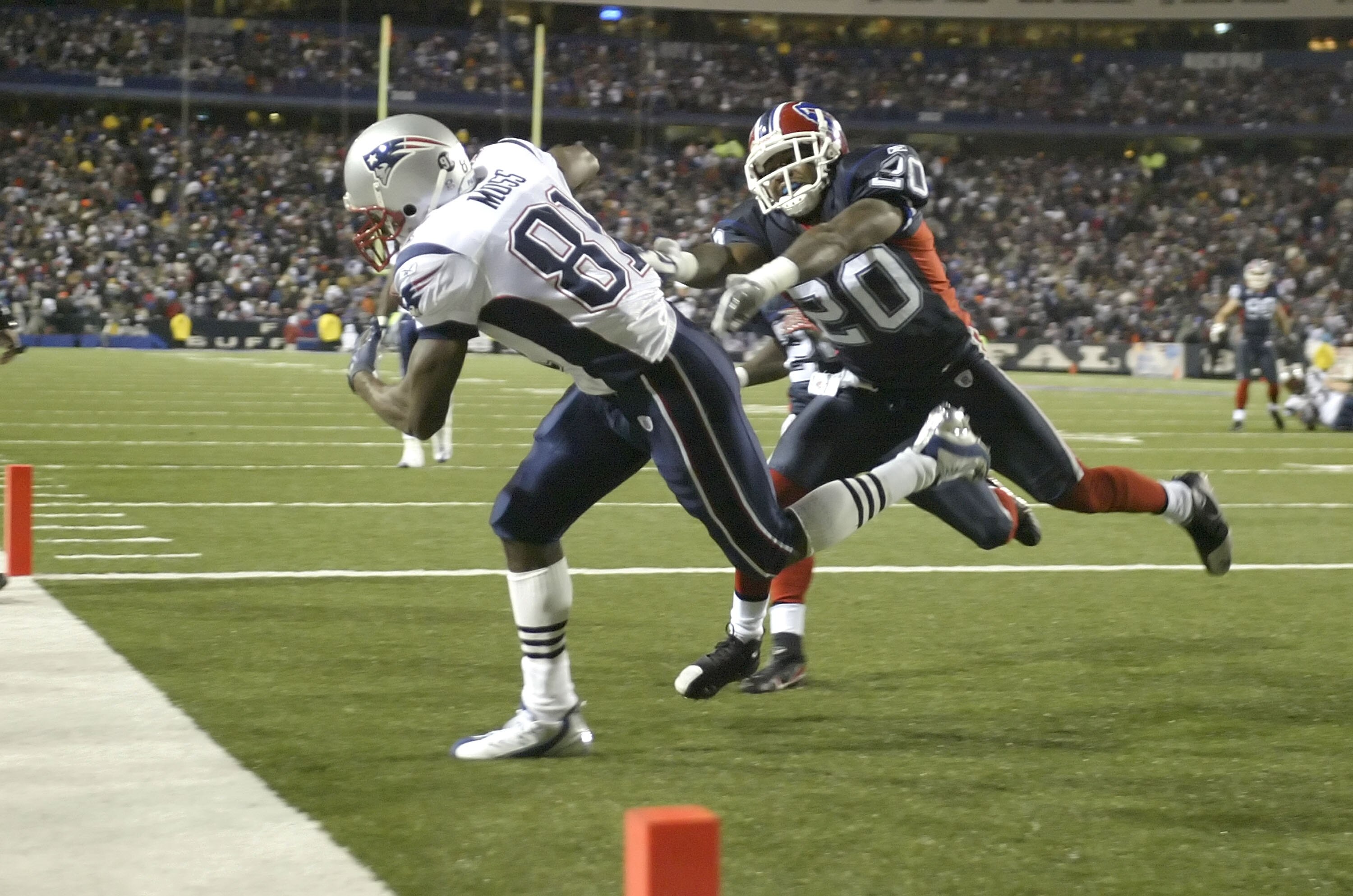 BUFFALO, NY - NOVEMBER 18:  Randy Moss #81 of the New England Patriots scores his fourth touchdown of the first half ahead of Donte Whitner #20 of the Buffalo Bills at Ralph Wilson Stadium November 18, 2007 in Orchard Park, New York.  (Photo by Rick Stewa
