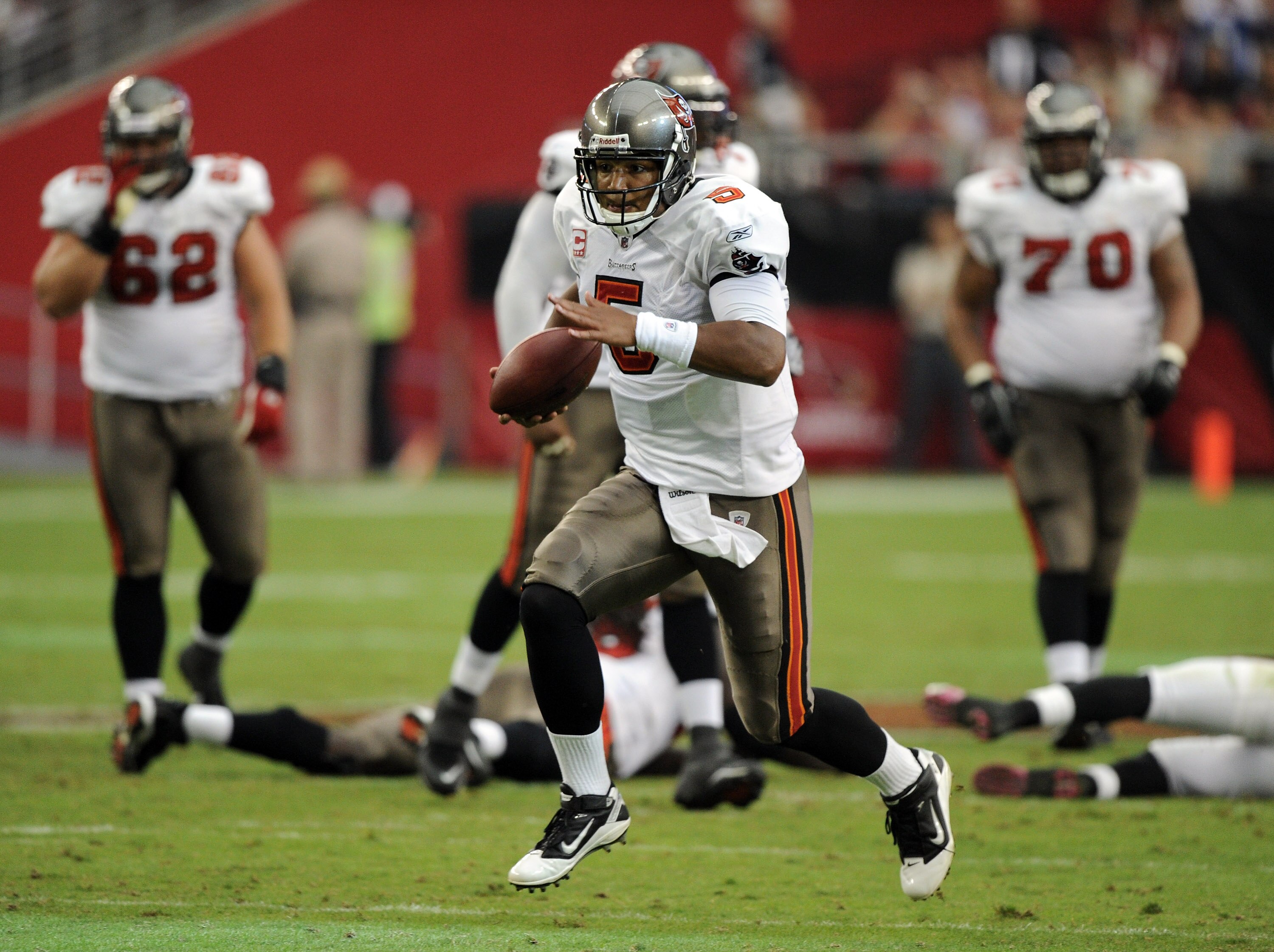 GLENDALE, AZ - OCTOBER 31:  Josh Freeman #5 of the Tampa Bay Buccaneers scrambles from the pocket against the Arizona Cardinals at University of Phoenix Stadium on October 31, 2010 in Glendale, Arizona.  (Photo by Harry How/Getty Images)