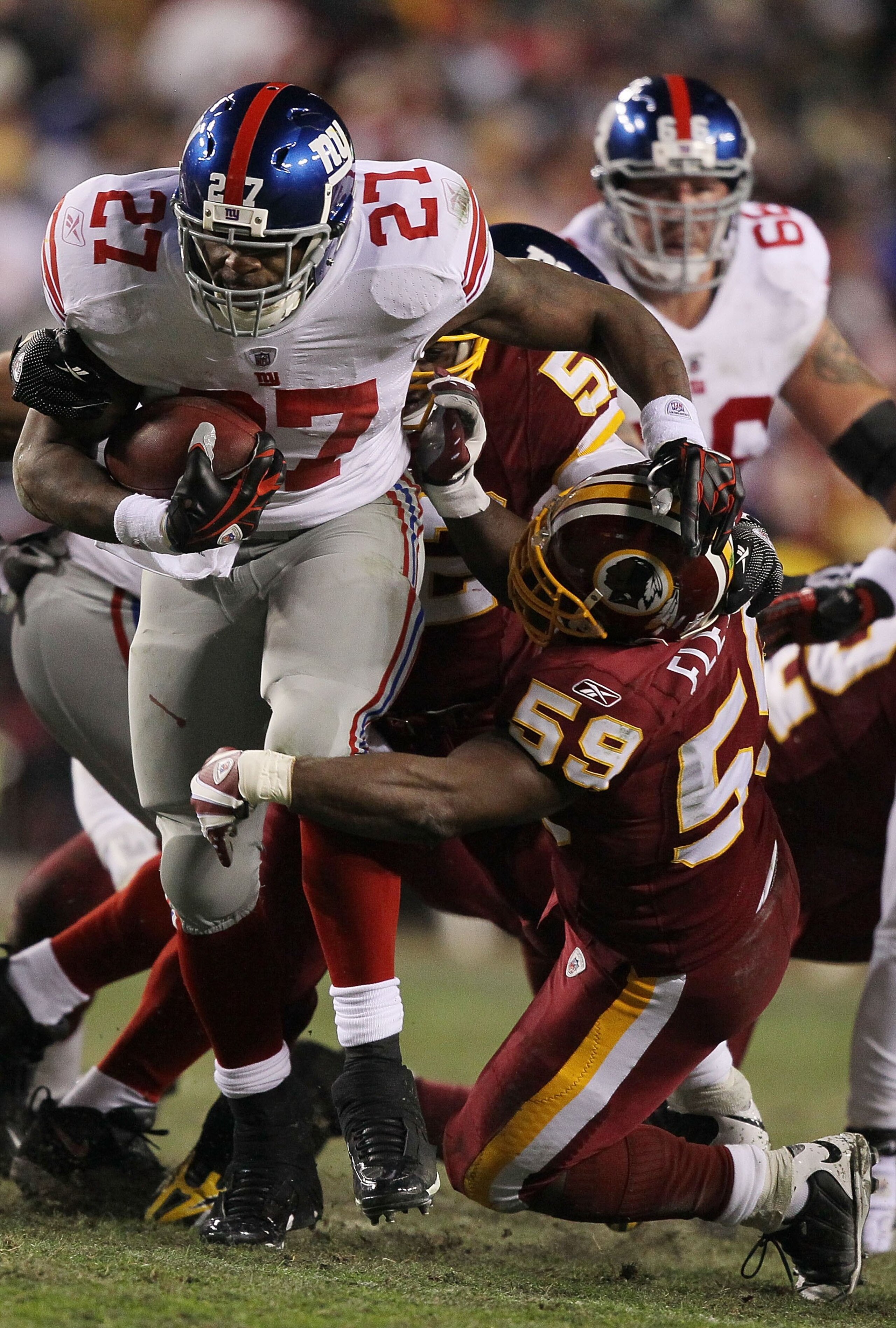 LANDOVER, MD - DECEMBER 21:  Brandon Jacobs #27 of the New York Giants runs past London Fletcher #59 of  the Washington Redskins during their game on December 21, 2009 at Fedex Field in Landover, Maryland.  (Photo by Al Bello/Getty Images)