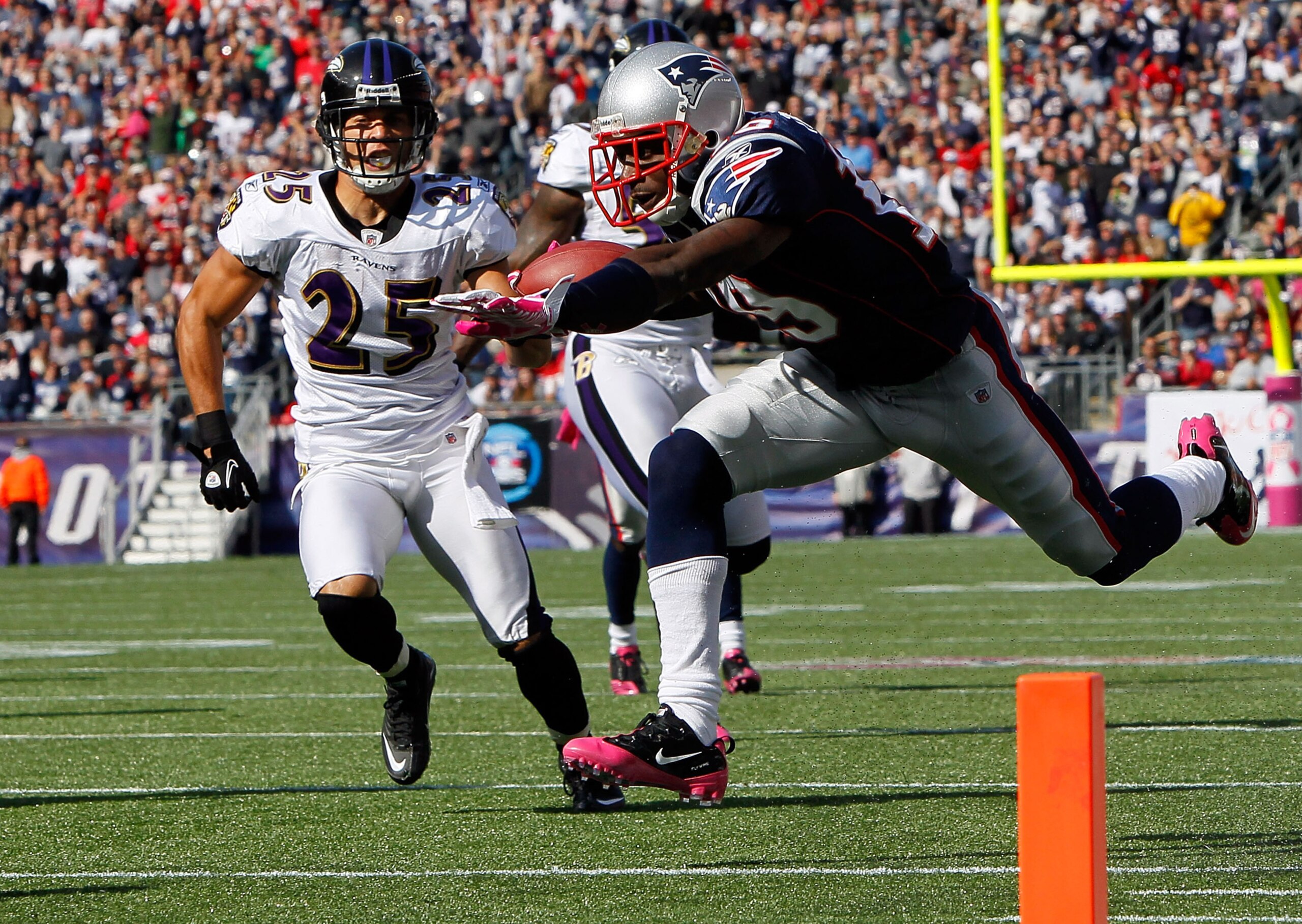 FOXBORO, MA - OCTOBER 17: Brandon Tate #19 of the New England Patriots gains yards against the defense of Chris Carr #25 and Terrell Suggs #55 of the Baltimore Ravens at Gillette Stadium on October 17, 2010 in Foxboro, Massachusetts. (Photo by Jim Rogash FOXBORO, MA - OCTOBER 17: Brandon Tate #19 of the New England Patriots gains yards against the defense of Chris Carr #25 and Terrell Suggs #55 of the Baltimore Ravens at Gillette Stadium on October 17, 2010 in Foxboro, Massachusetts. (Photo by Jim Rogash