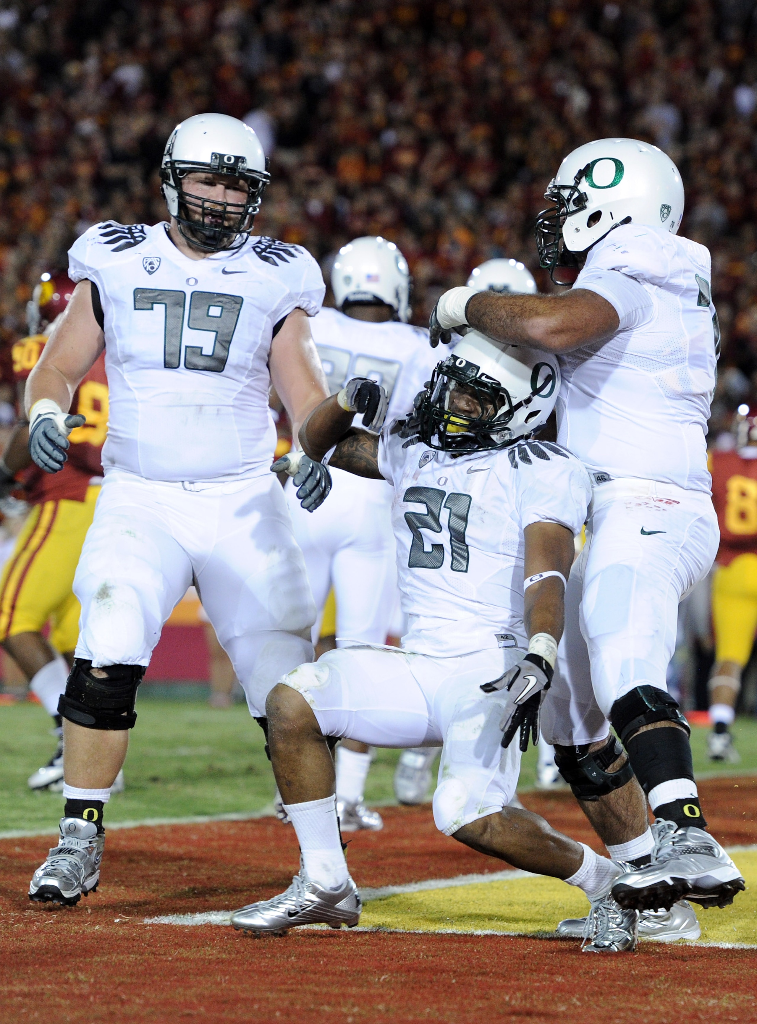 LOS ANGELES, CA - OCTOBER 30:  LaMichael James #21 of the Oregon Ducks celebrates his touchdown with Mark Asper #79 and Ramsen Golpashin #70 for a 43-32 lead over the USC Trojans during the fourth quarter at Los Angeles Memorial Coliseum on October 30, 20