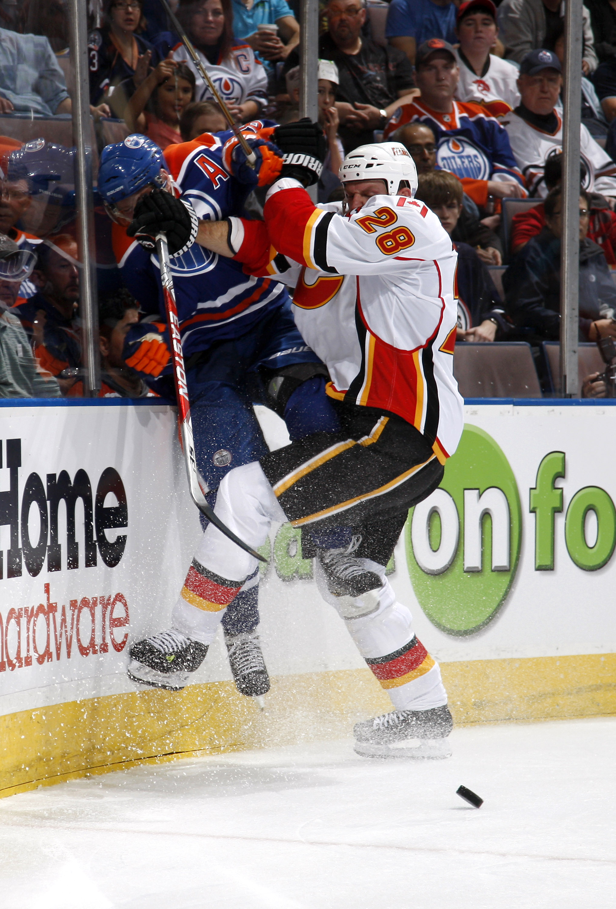 EDMONTON, CANADA - OCTOBER 7:  Robyn Regehr #28 of the Calgary Flames checks Ales Hemsky #83 of the Edmonton Oilers in first-period action at Rexall Place October 7, 2010 in Edmonton, Alberta, Canada. (Photo by Dale MacMillan/Getty Images)