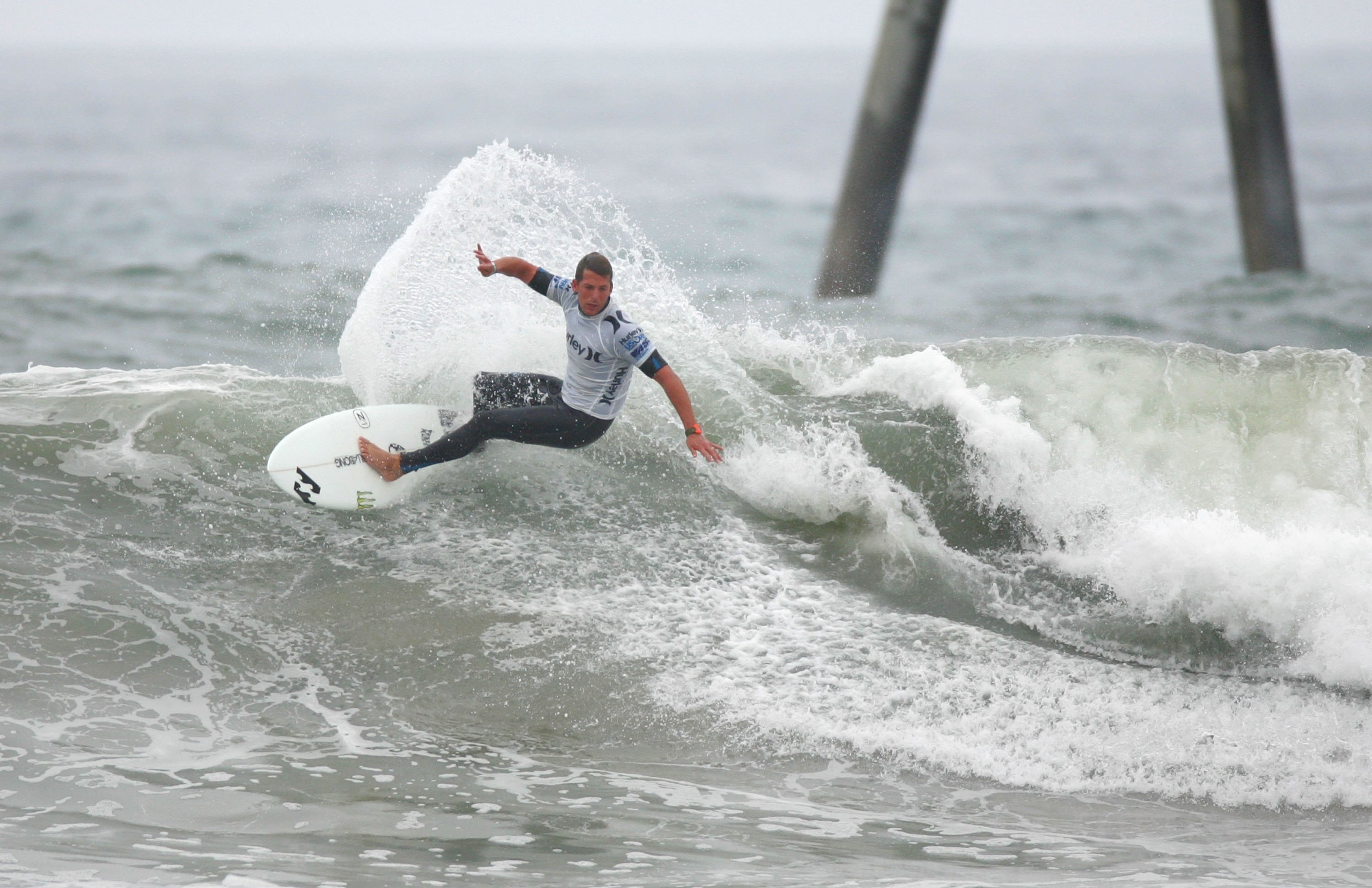 HUNTINGTON BEACH, CA - JULY 24:  Andy Irons (Hawaii) turns off the top in Heat 4 of the Men's Round of 24 during the 2009 Hurley U.S. Open of Surfing on July 24, 2009 in Huntington Beach, California.  (Photo by Victor Decolongon/Getty Images)