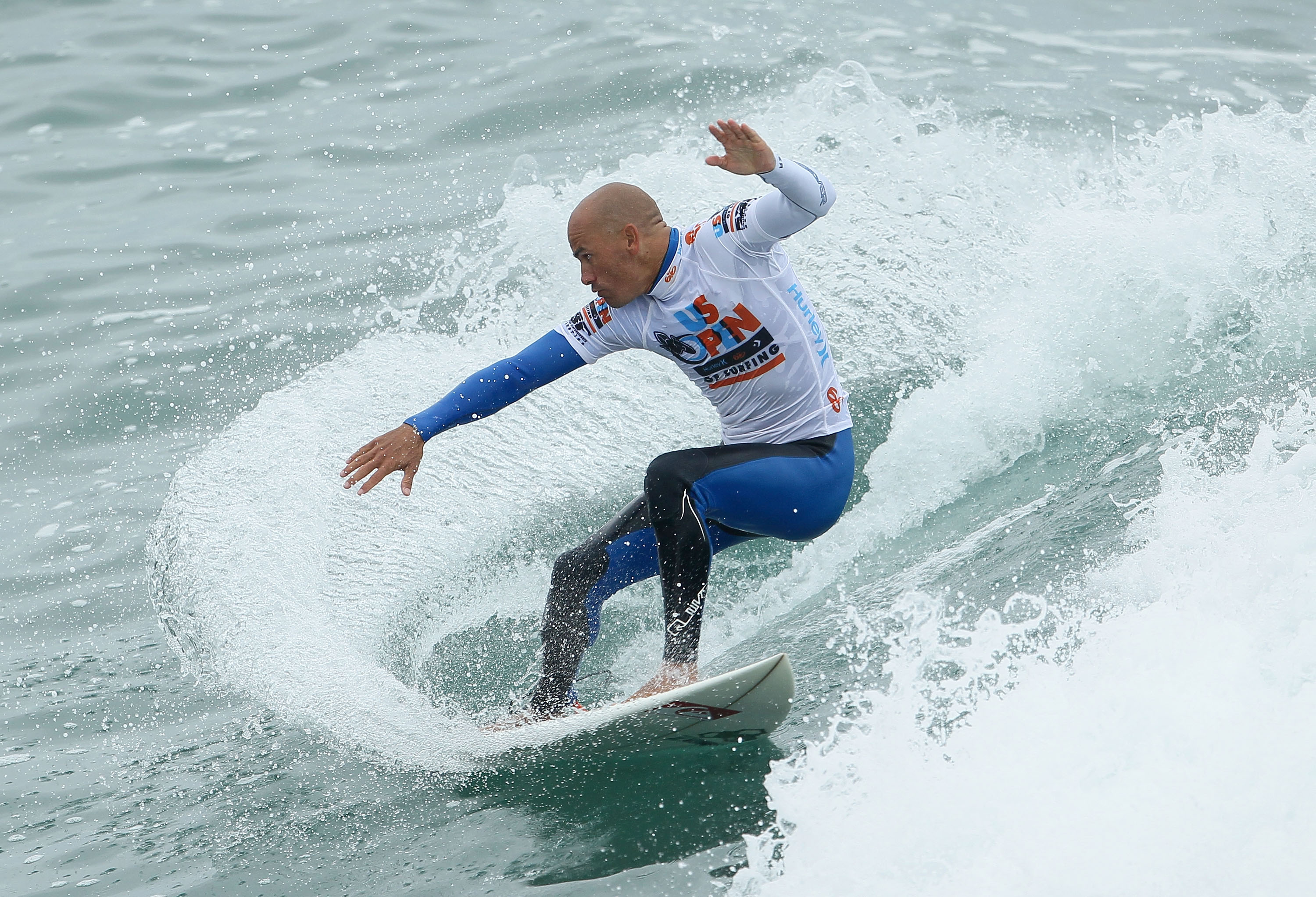 HUNTINGTON BEACH, CA - AUGUST 08:  Kelly Slater executes a cut back during the Hurley U.S. Open of Surfing on August 8, 2010 in Huntington Beach, California.  (Photo by Jeff Gross/Getty Images)