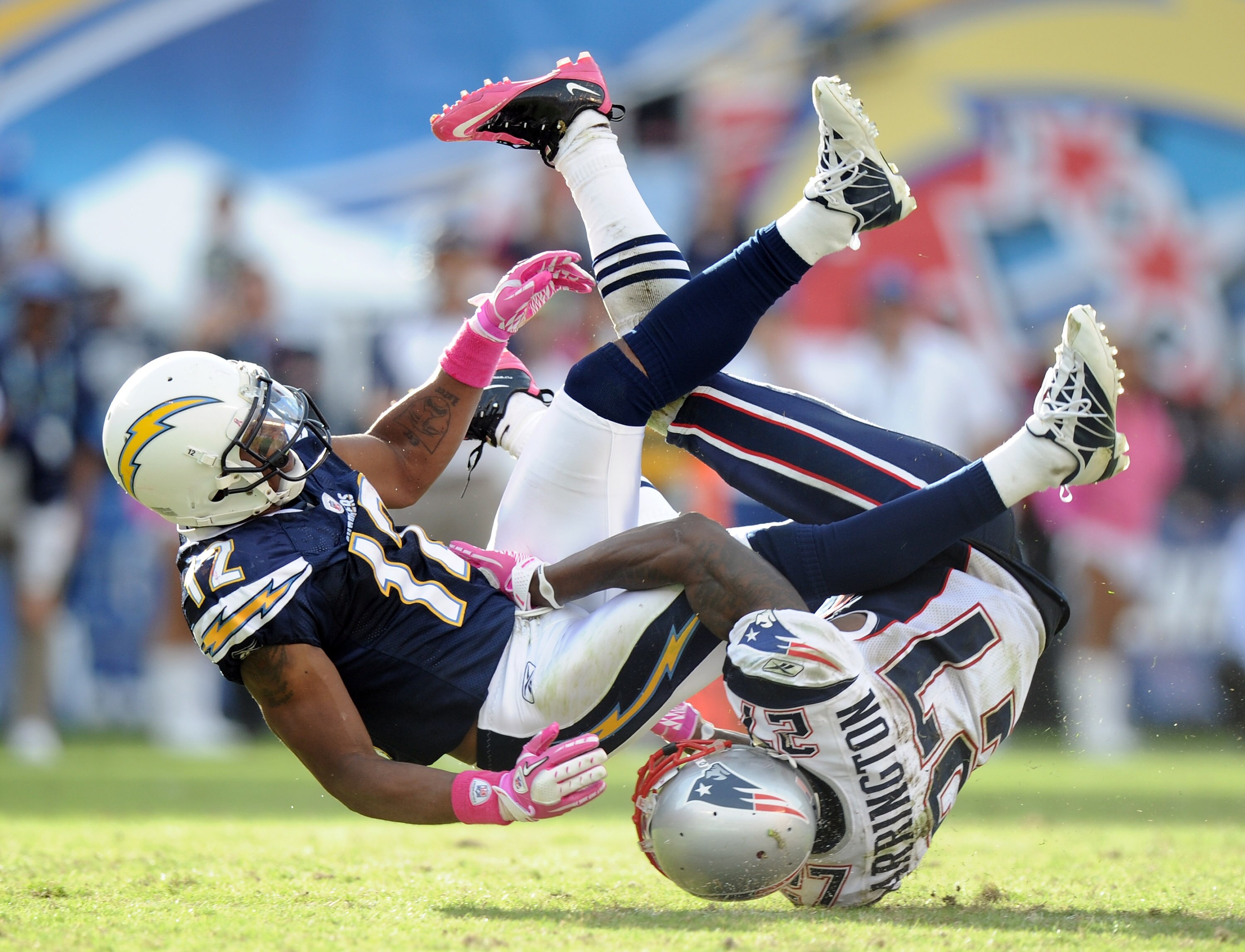 SAN DIEGO - OCTOBER 24:  Patrick Crayton #12 of the San Diego Chargers takes a hit from Kyle Arrington #27 of the New England Patriots at Qualcomm Stadium on October 24, 2010 in San Diego, California.  (Photo by Harry How/Getty Images)