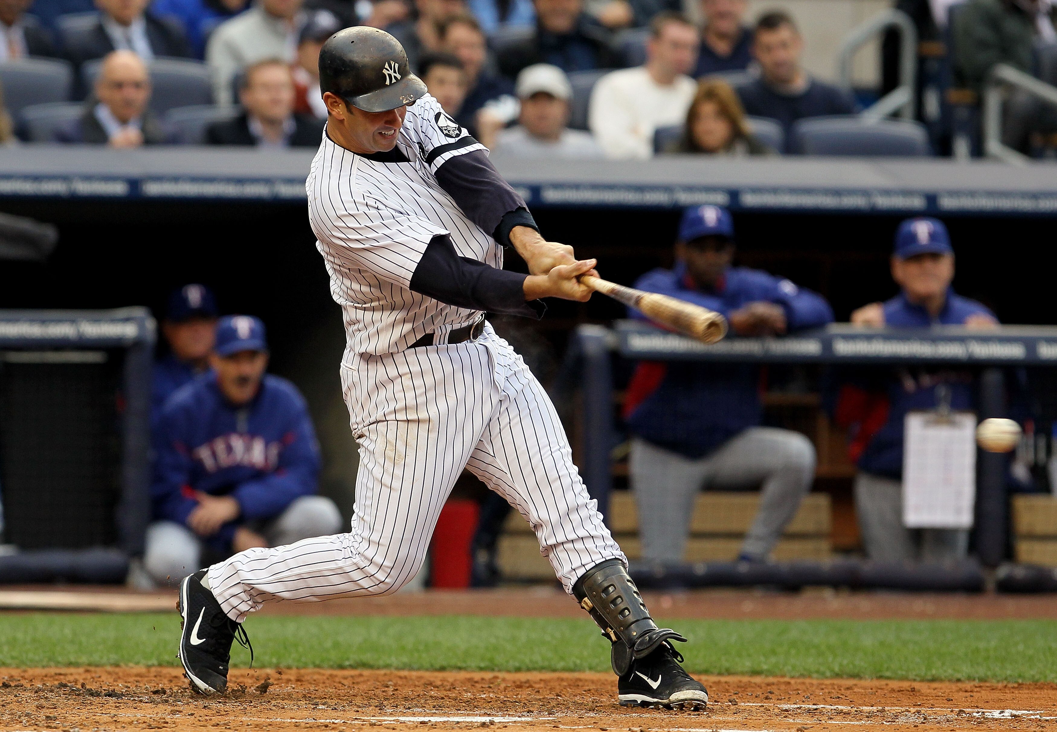 NEW YORK - OCTOBER 20:  Jorge Posada #20 of the New York Yankees hits a RBI single in the bottom of the second inning against the Texas Rangers in Game Five of the ALCS during the 2010 MLB Playoffs at Yankee Stadium on October 20, 2010 in the Bronx boroug