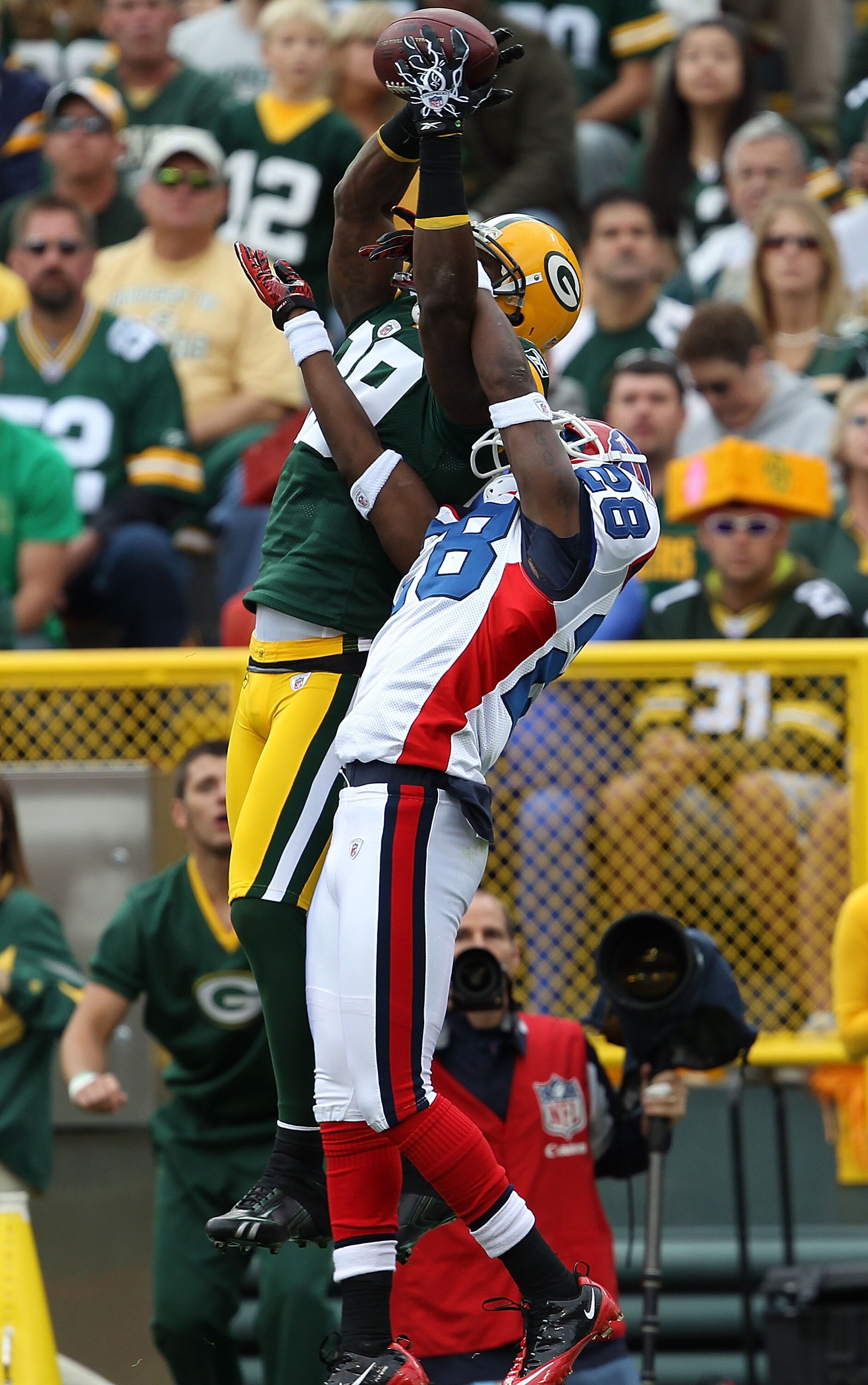GREEN BAY, WI - SEPTEMBER 19: James Jones #89 of the Green Bay Packers leaps to try and catch a pass under pressure from Leodis McKelvin #28 of the Buffalo Bills at Lambeau Field on September 19, 2010 in Green Bay, Wisconsin. The Packers defeated the Bill