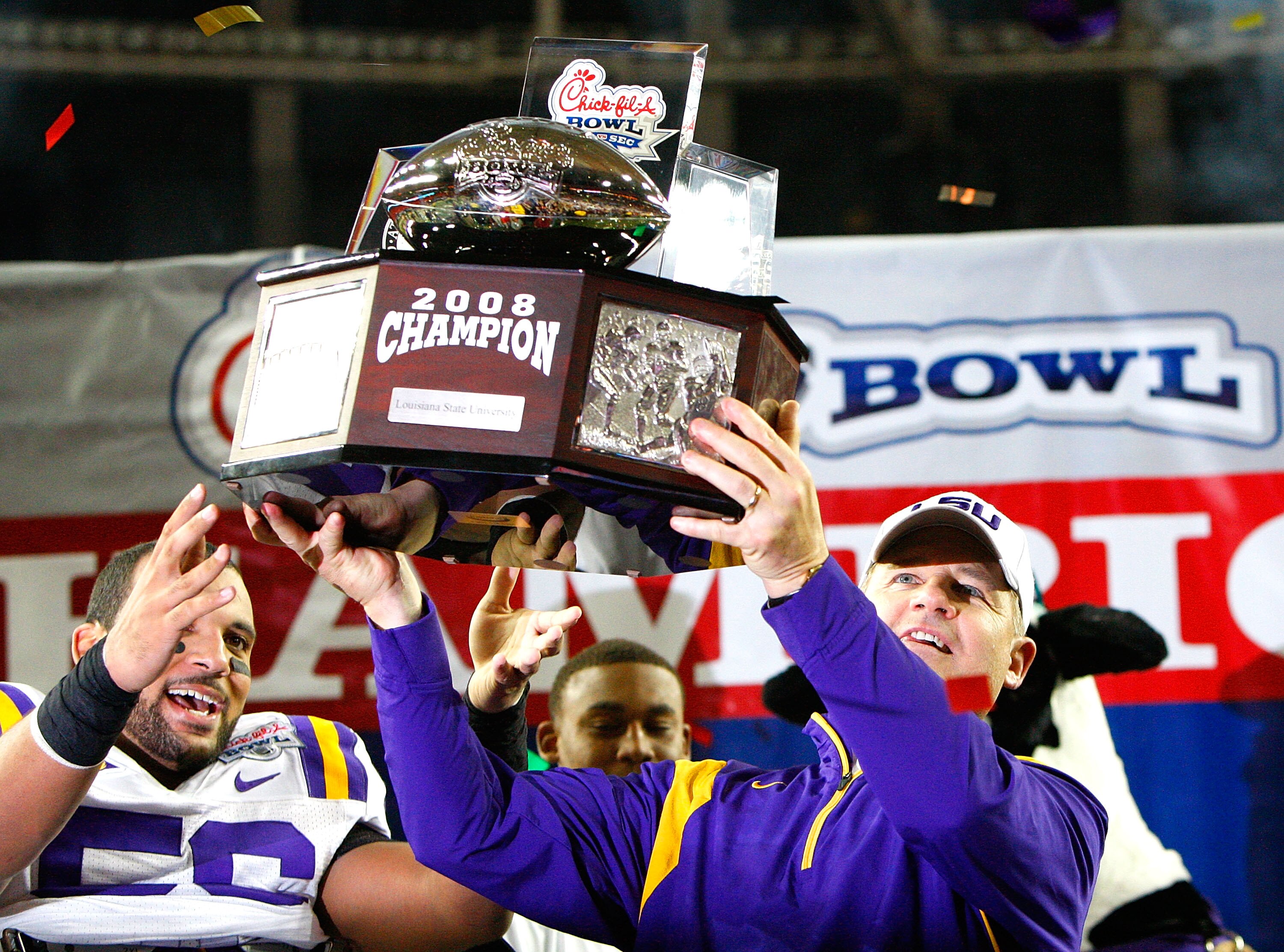 ATLANTA - DECEMBER 31:  Head coach Les Miles and Perry Riley #56 of the LSU Tigers lift up the trophy after a 38-3 win over the Georgia Tech Yellow Jackets in the Chick-fil-A Bowl on December 31, 2008 at the Georgia Dome in Atlanta, Georgia.  (Photo by Ke