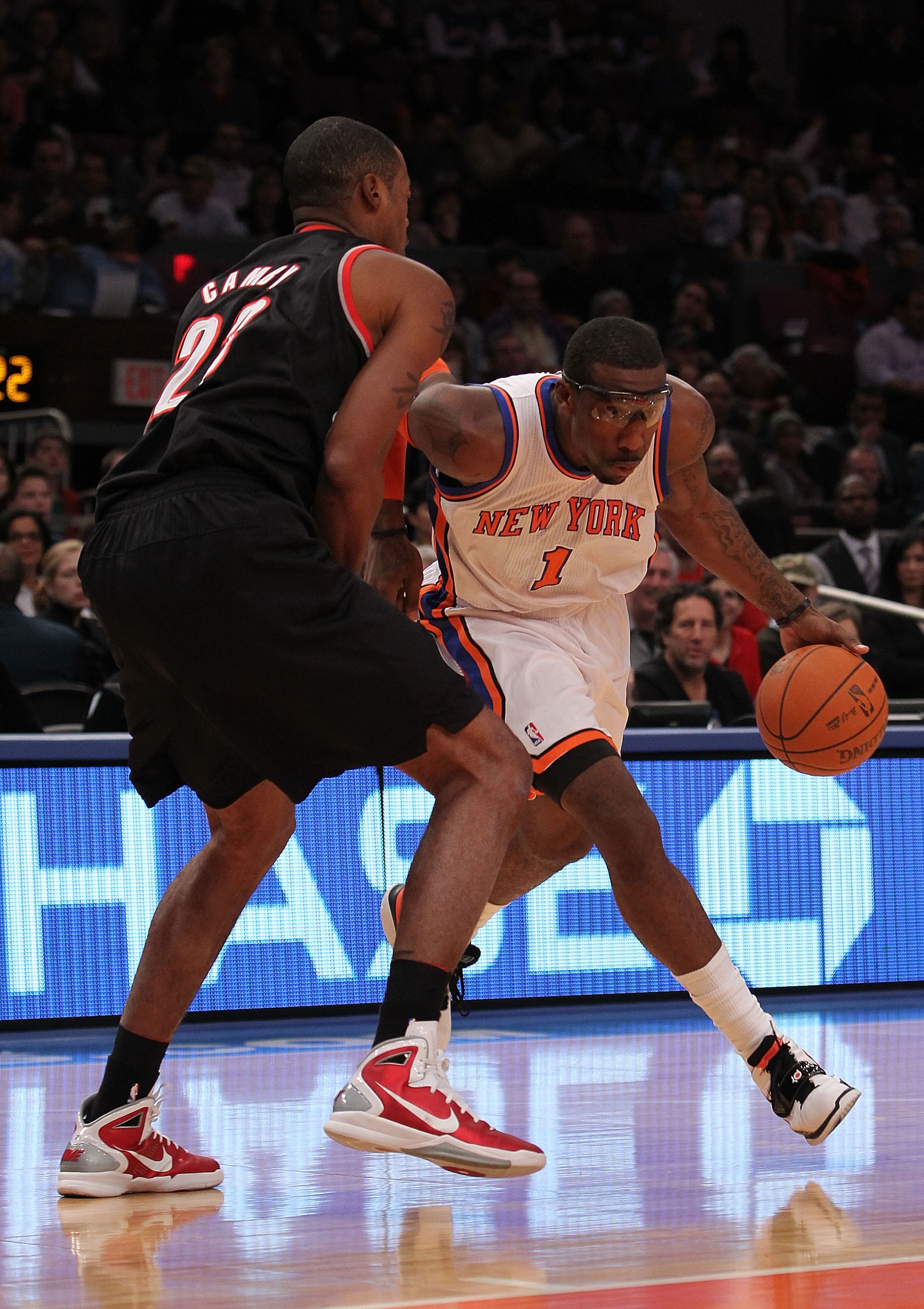NEW YORK - OCTOBER 30:  Amar'e Stoudemire #1 of the New York Knicks drives against Marcus Camby #23 of the Portland Trail Blazers at Madison Square Garden on October 30, 2010 in New York City. NOTE TO USER: User expressly acknowledges and agrees that, by 