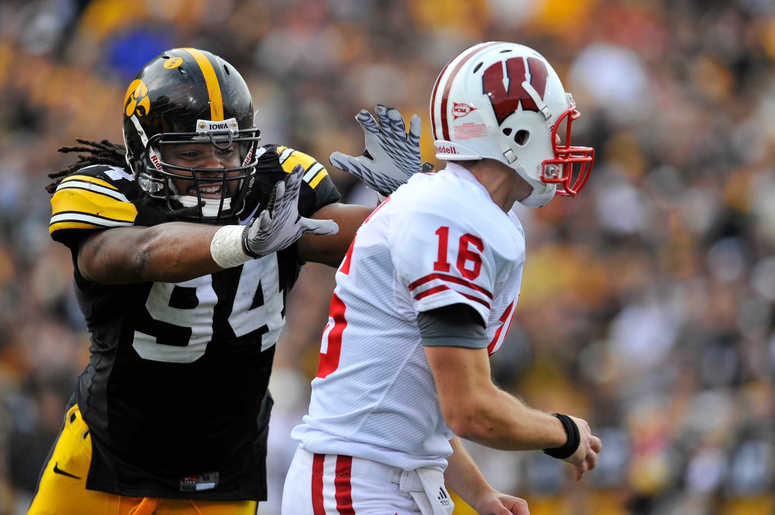IOWA CITY, IA - OCTOBER 23: Defensive lineman Adrian Clayborn #94 of the University of Iowa Hawkeyes puts pressure on quarterback Scott Tolzien #16 of the Wisconsin Badgers during the first half of play at Kinnick Stadium on October 23, 2010 in Iowa City,