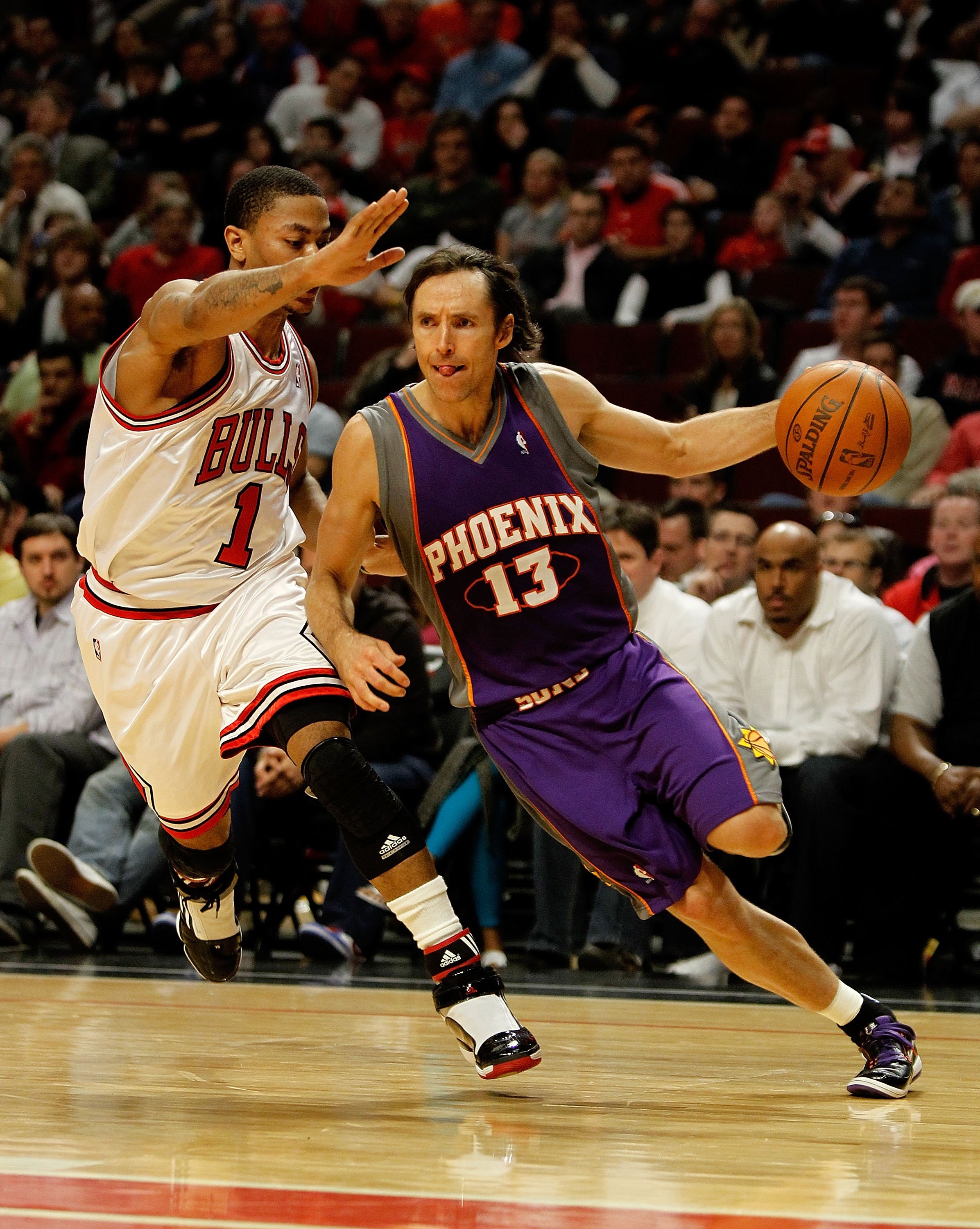 CHICAGO - MARCH 30: Steve Nash #13 of the Phoenix Suns drives around Derrick Rose #1 of the Chicago Bulls at the United Center on March 30, 2010 in Chicago, Illinois. The Suns defeated the Bulls 111-105. NOTE TO USER: User expressly acknowledges and agree