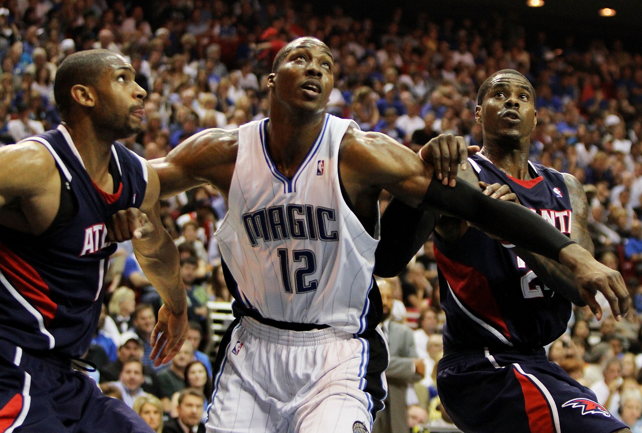ORLANDO, FL - MAY 06:  Al Horford #15 and Marvin Williams #24 of the Atlanta Hawks fight for position with Dwight Howard #12 of the Orlando Magic in Game Two of the Eastern Conference Semifinals during the 2010 NBA Playoffs at Amway Arena on May 6, 2010 i
