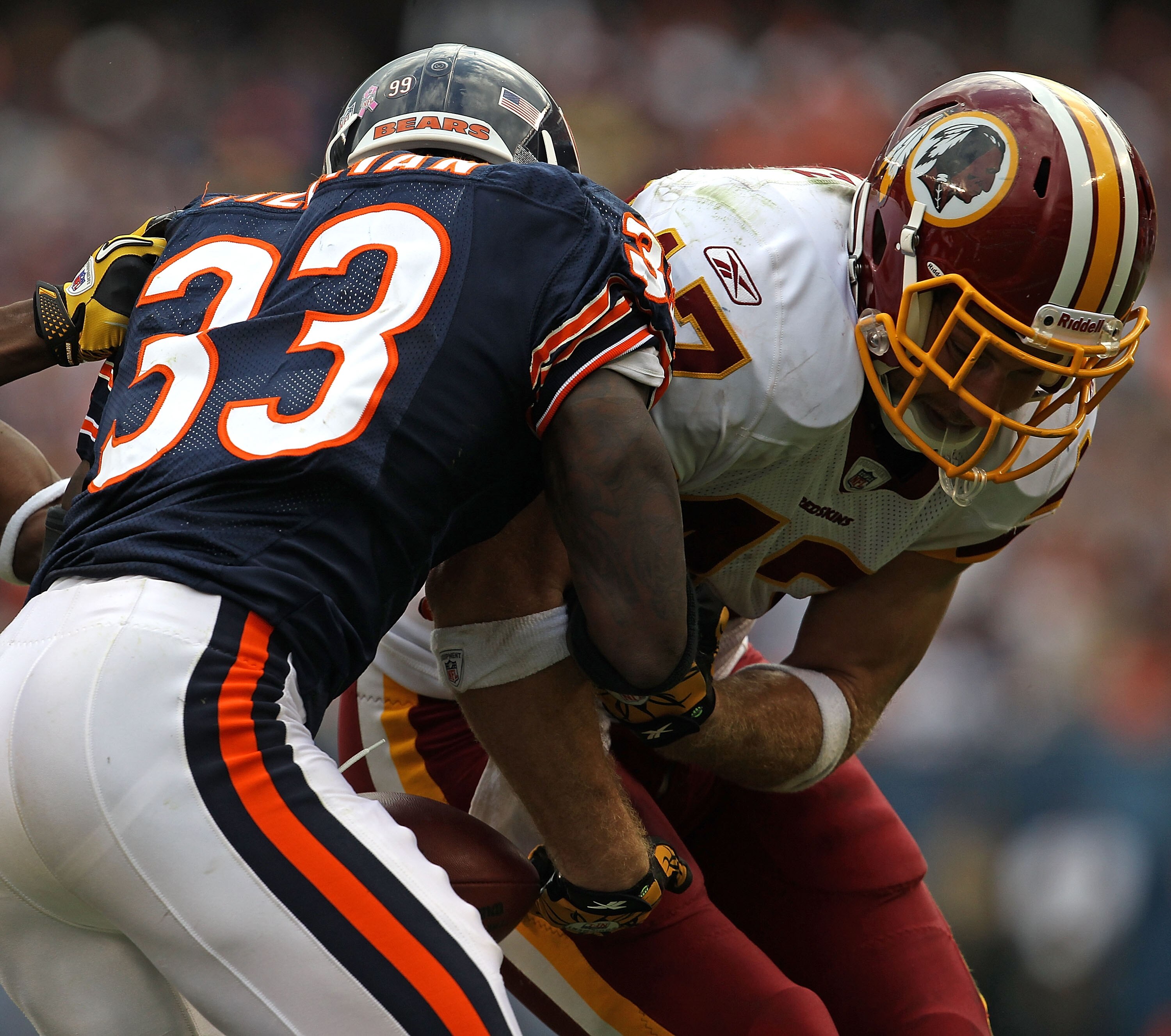 CHICAGO - OCTOBER 24: Chris Cooley #47 of the Washington Redskins fumbles the ball as he is hit by Charles Tillman #33 of the Chicago Bears at Soldier Field on October 24, 2010 in Chicago, Illinois. The Redskins defeated the Bears 17-14. (Photo by Jonatha