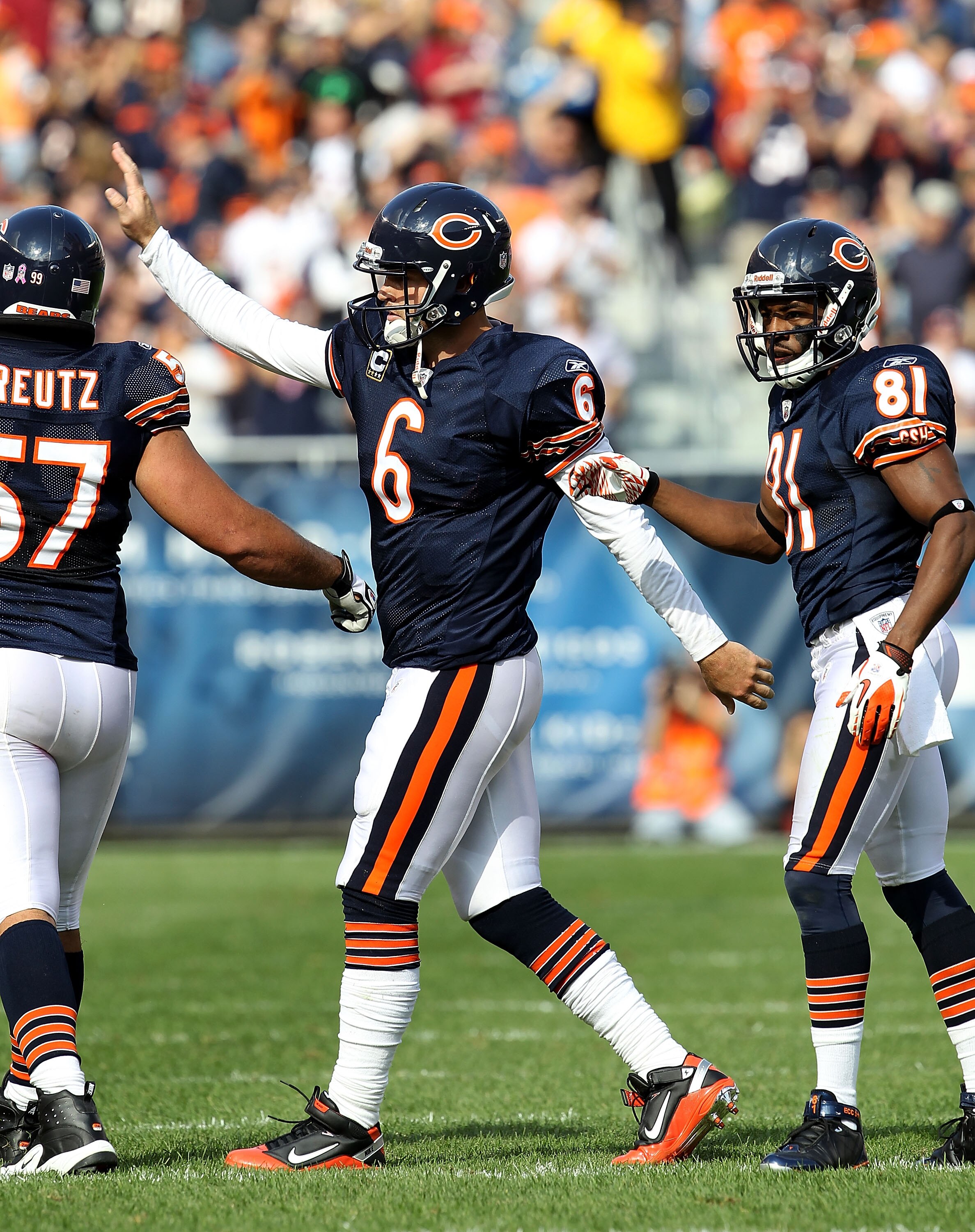 CHICAGO - OCTOBER 24: Jay Cutler #6 of the Chicago Bears celebrates a touchdown pass with teammate Olin Kreutz #57 and Rashied Davis #81 against the Washington Redskins at Soldier Field on October 24, 2010 in Chicago, Illinois. The Redskins defeated the B