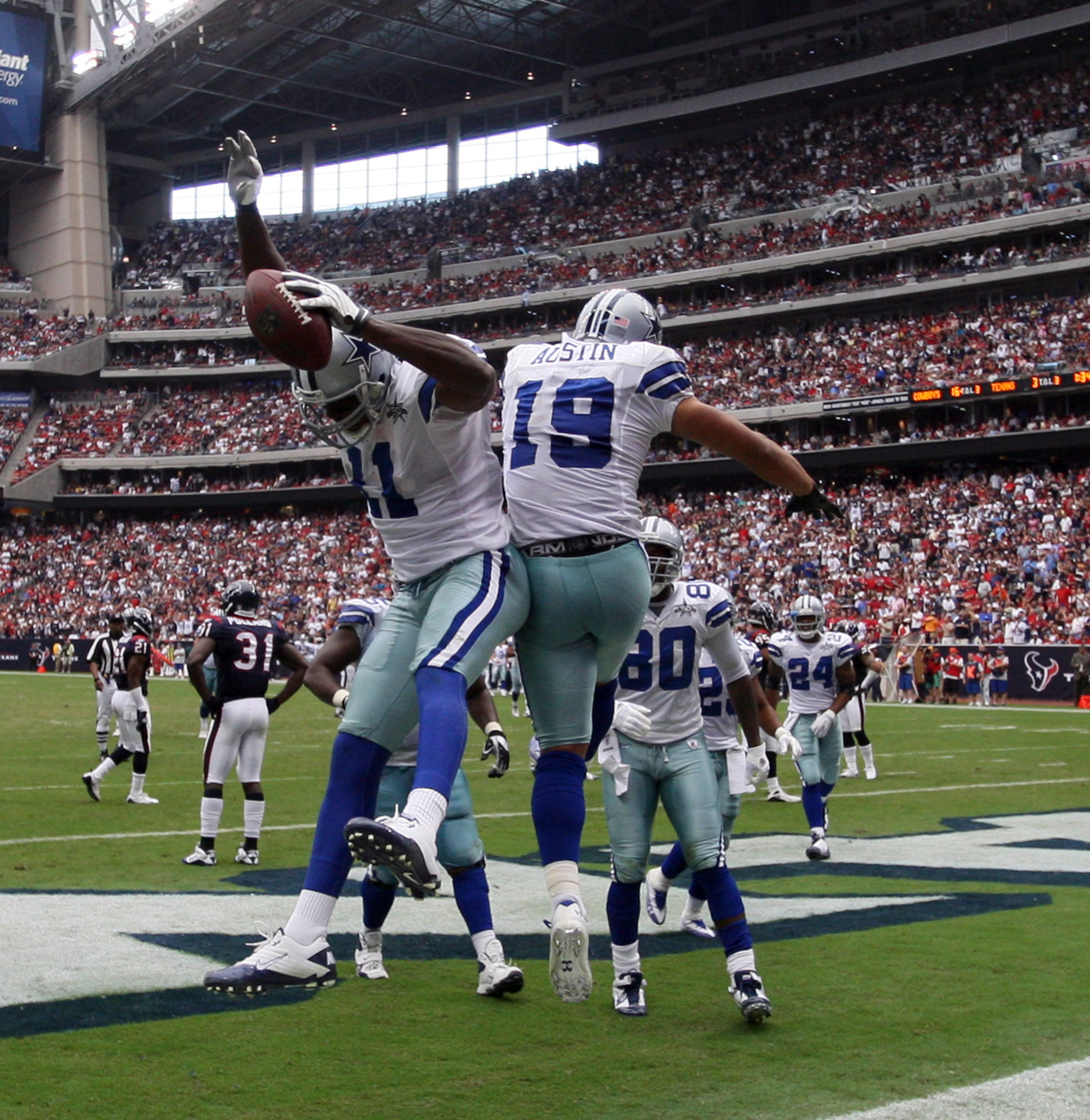 HOUSTON - SEPTEMBER 26:  Wide receiver Roy Williams #11 and Miles Austin #11 celebrate after scoring on a 15 yard pass from Tony Romo in the third quarter at Reliant Stadium on September 26, 2010 in Houston, Texas.  (Photo by Bob Levey/Getty Images)