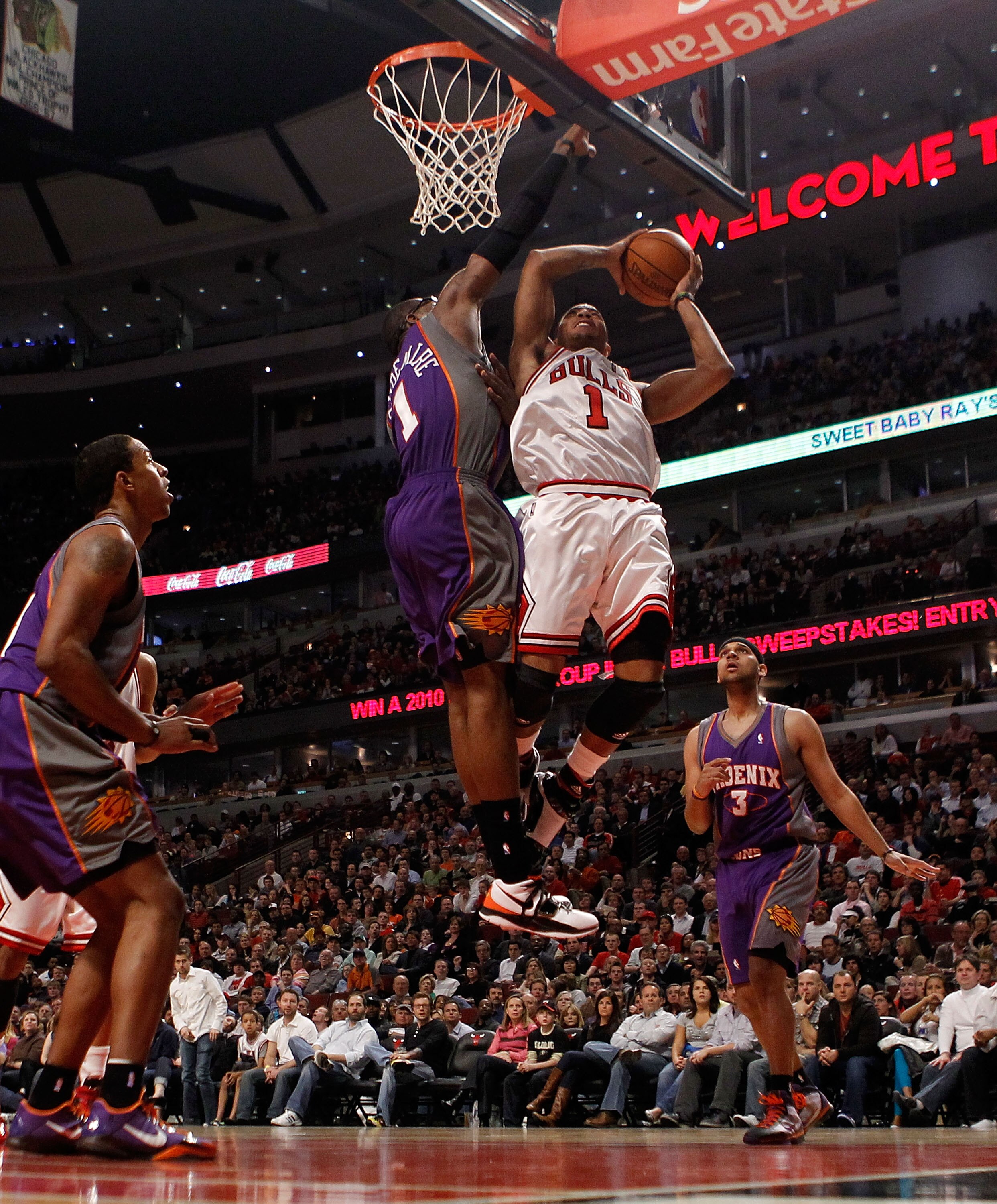 CHICAGO - MARCH 30: Derrick Rose #1 of the Chicago Bulls puts up a shot against Amar'e Stoudemire #1 of the Phoenix Suns at the United Center on March 30, 2010 in Chicago, Illinois. The Suns defeated the Bulls 111-105. NOTE TO USER: User expressly acknowl