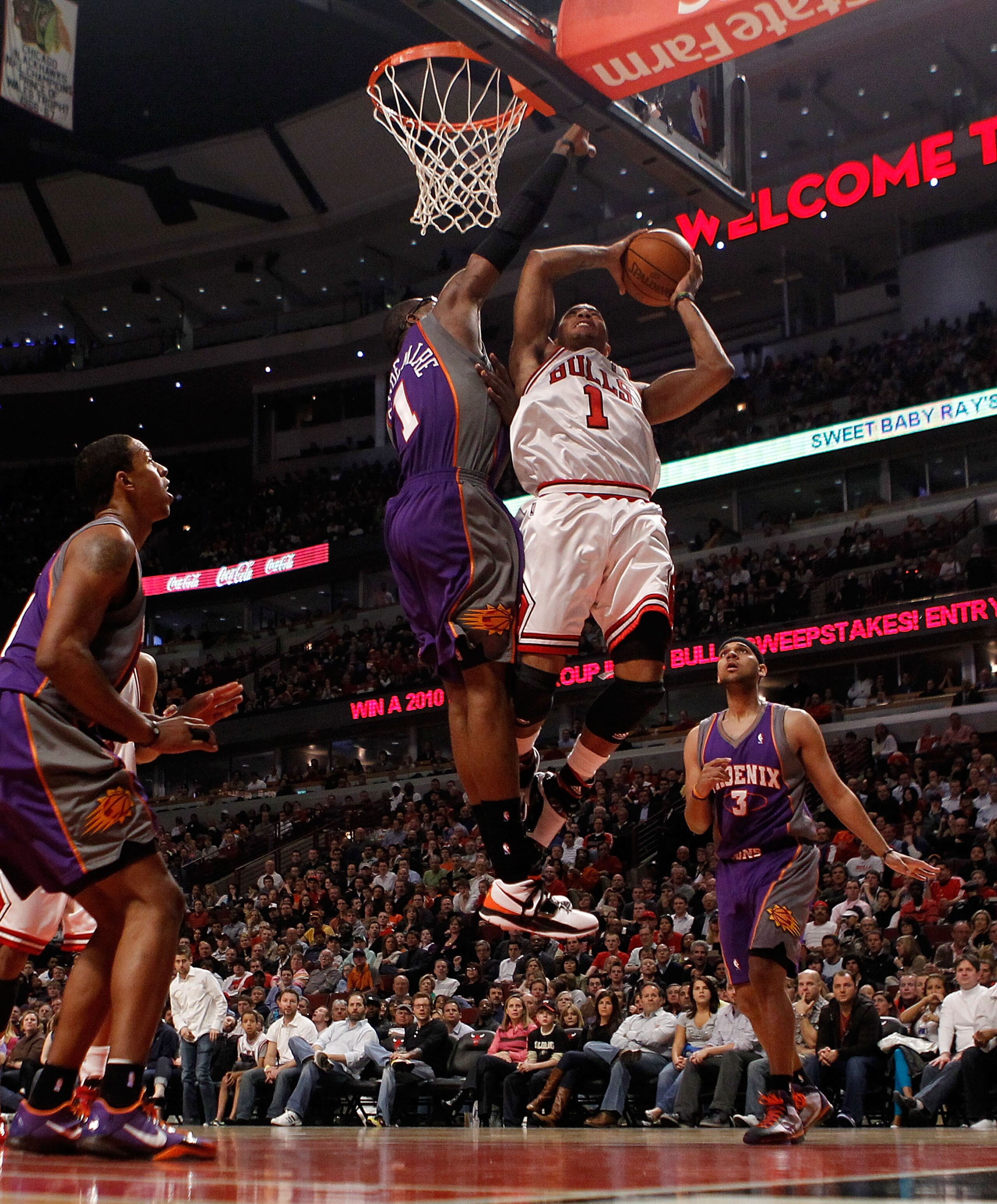 CHICAGO - MARCH 30: Derrick Rose #1 of the Chicago Bulls puts up a shot against Amar'e Stoudemire #1 of the Phoenix Suns at the United Center on March 30, 2010 in Chicago, Illinois. The Suns defeated the Bulls 111-105. NOTE TO USER: User expressly acknowl CHICAGO - MARCH 30: Derrick Rose #1 of the Chicago Bulls puts up a shot against Amar'e Stoudemire #1 of the Phoenix Suns at the United Center on March 30, 2010 in Chicago, Illinois. The Suns defeated the Bulls 111-105. NOTE TO USER: User expressly acknowl