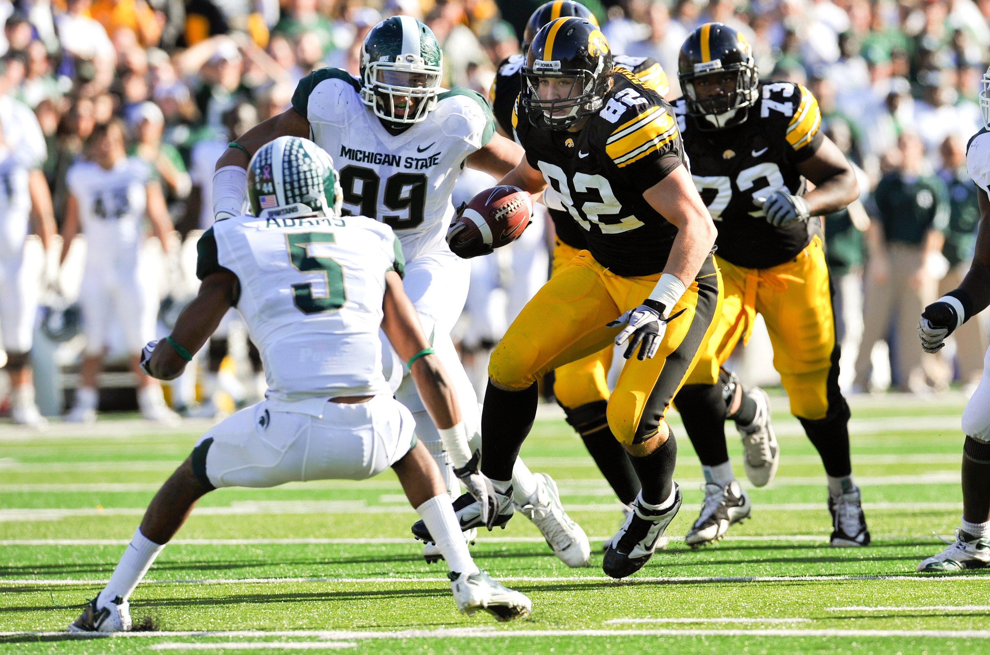IOWA CITY, IA - OCTOBER 30: Tight end Allen Reisner #82 of the University of Iowa Hawkeyes runs the ball as corner back Johnny Adams #5 of the Michigan State Spartans defends during the first half of play at Kinnick Stadium on October 30, 2010 in Iowa Cit IOWA CITY, IA - OCTOBER 30: Tight end Allen Reisner #82 of the University of Iowa Hawkeyes runs the ball as corner back Johnny Adams #5 of the Michigan State Spartans defends during the first half of play at Kinnick Stadium on October 30, 2010 in Iowa Cit