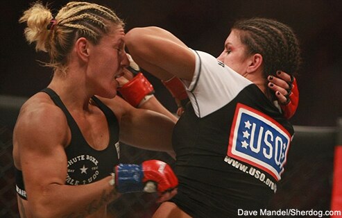 Carano's elbow hits Cyborg's face.