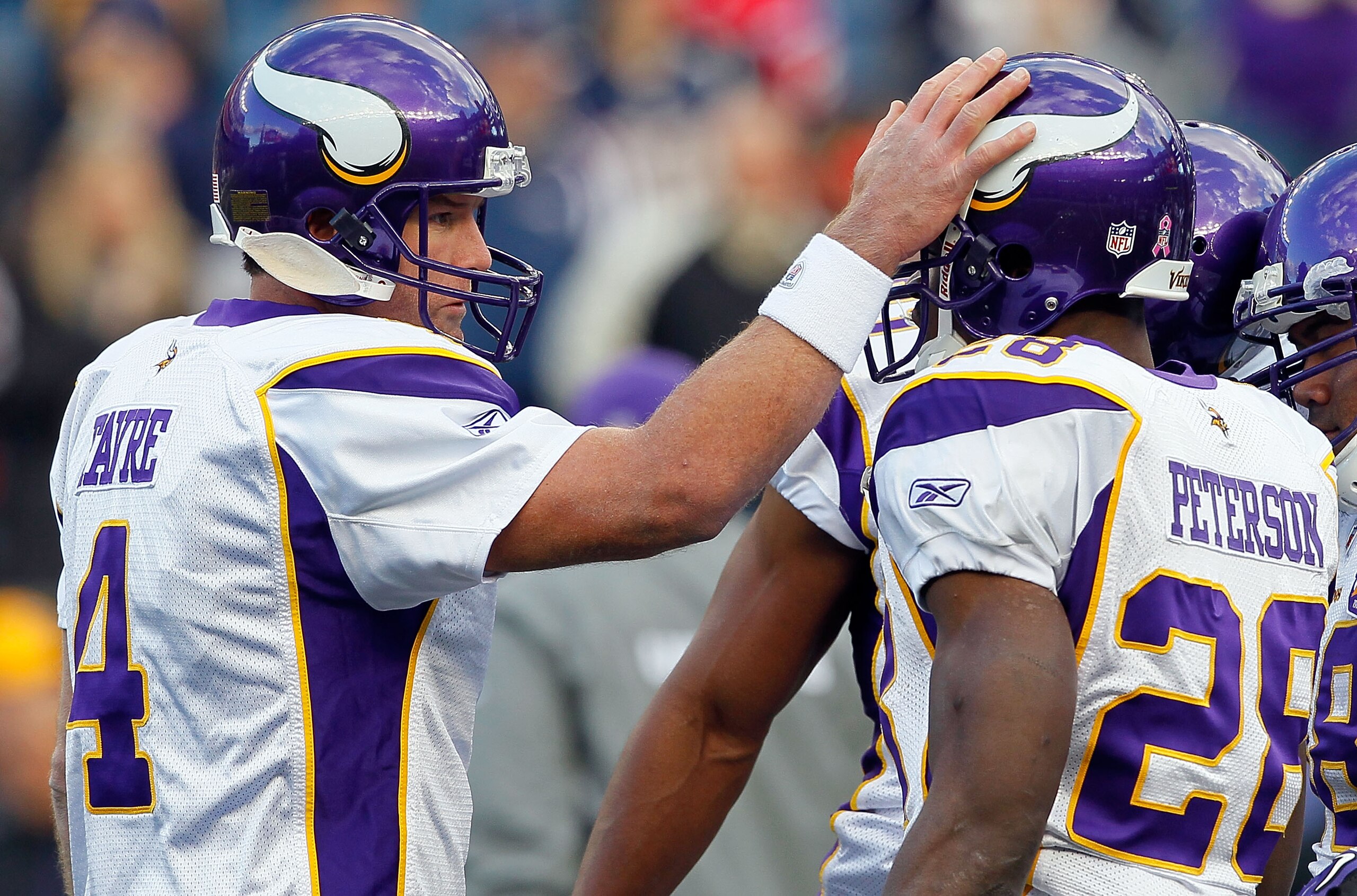 FOXBORO, MA - OCTOBER 31:  Brett Favre #4 of the Minnesota Vikings interacts with teammate Adrian Peterson #28 before a game against the New England Patriots at Gillette Stadium on October 31, 2010 in Foxboro, Massachusetts. (Photo by Jim Rogash/Getty Ima