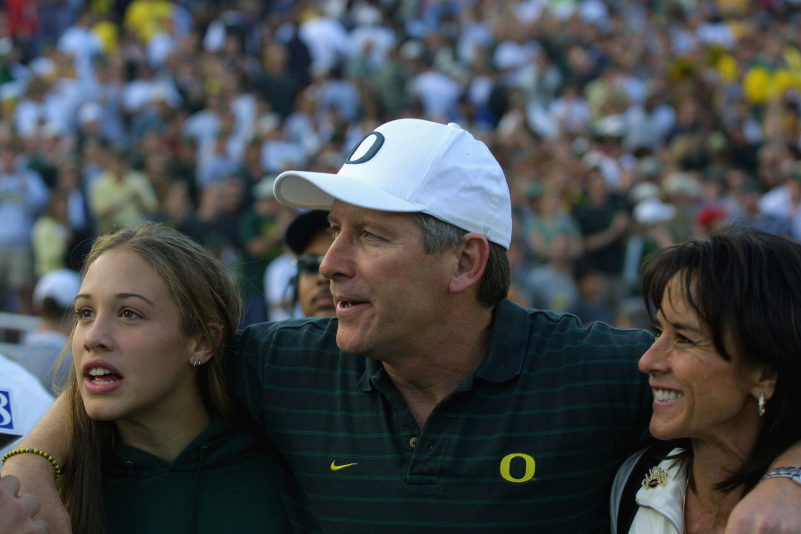 PASADENA, CA - NOVEMBER 10:  Head coach Mike Belotti of the Oregon Ducks puts his arms around daughter Keri and wife Colleen after winning the Pac-10 Conference football game on Novemver 10, 2001 against the UCLA Bruins at the Rose Bowl in Pasadena, Calif
