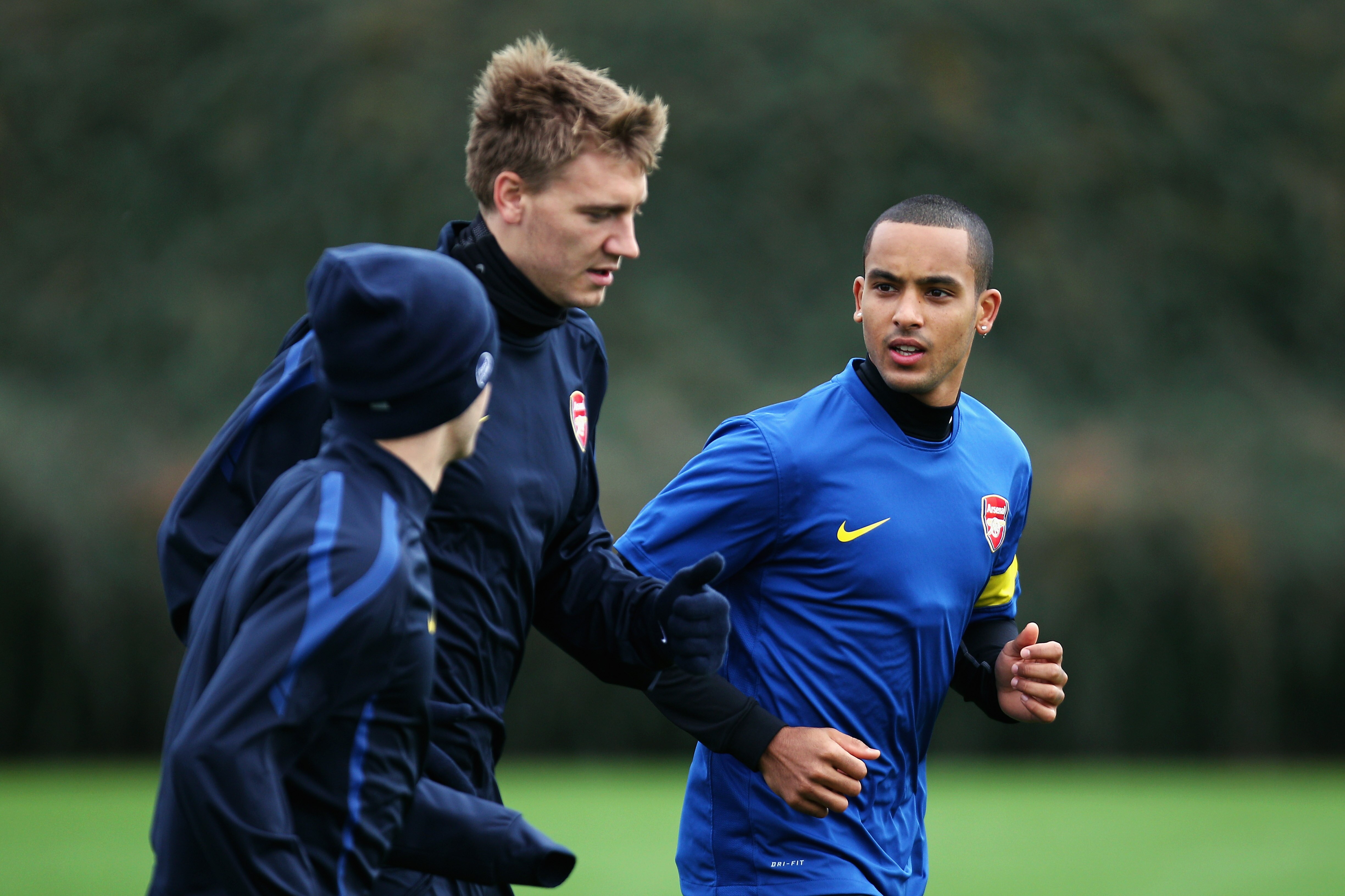 ST ALBANS, ENGLAND - NOVEMBER 02: (L-R) Jack Wilshere, Nicklas Bendtner and Theo Walcott lead the warm up during a training session ahead of the UEFA Champions League Group H match against Shakhtar Donetsk at the club's complex at London Colney on Novemb ST ALBANS, ENGLAND - NOVEMBER 02: (L-R) Jack Wilshere, Nicklas Bendtner and Theo Walcott lead the warm up during a training session ahead of the UEFA Champions League Group H match against Shakhtar Donetsk at the club's complex at London Colney on Novemb