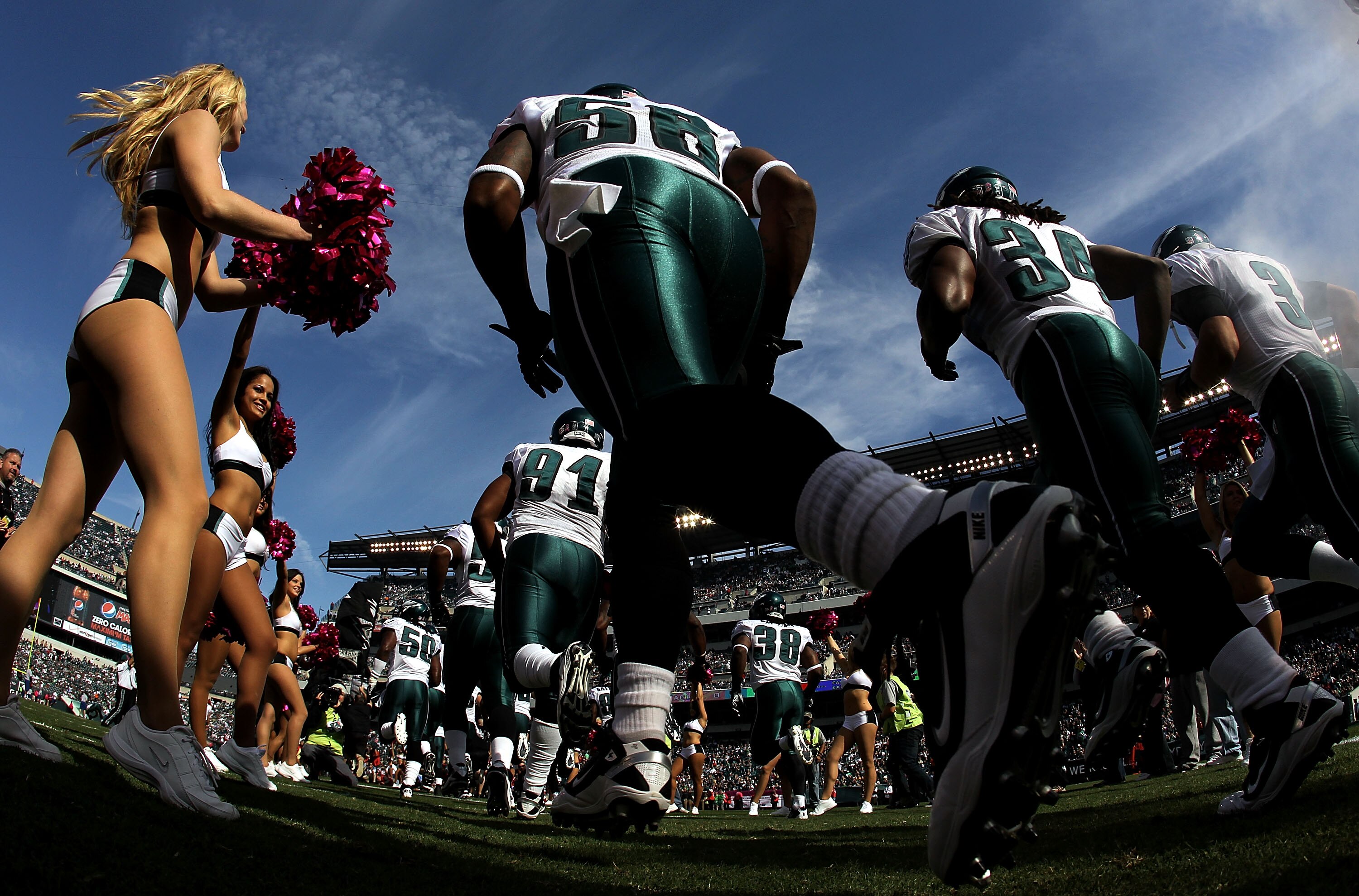 PHILADELPHIA - OCTOBER 17:  A Philadelphia Eagles cheerleader greets the Eagles as they take the field against the Atlanta Falcons during their game at Lincoln Financial Field on October 17, 2010 in Philadelphia, Pennsylvania.  (Photo by Al Bello/Getty Im