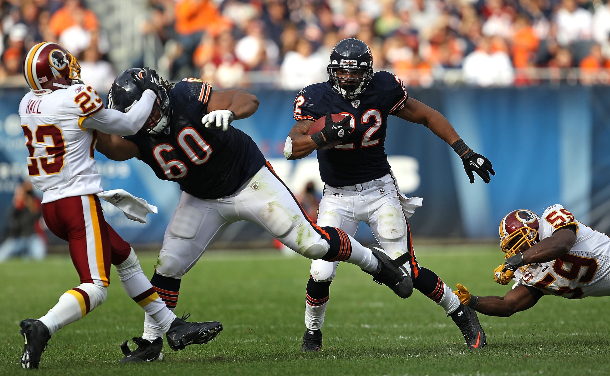 CHICAGO - OCTOBER 24: Matt Forte #22 of the Chicago Bears avoids a tackle attempt by London Fletcher #59 of the Washington Redskins as teammate Lance Louis #60 blocks DeAngelo Hall #23 at Soldier Field on October 24, 2010 in Chicago, Illinois. The Redskin CHICAGO - OCTOBER 24: Matt Forte #22 of the Chicago Bears avoids a tackle attempt by London Fletcher #59 of the Washington Redskins as teammate Lance Louis #60 blocks DeAngelo Hall #23 at Soldier Field on October 24, 2010 in Chicago, Illinois. The Redskin