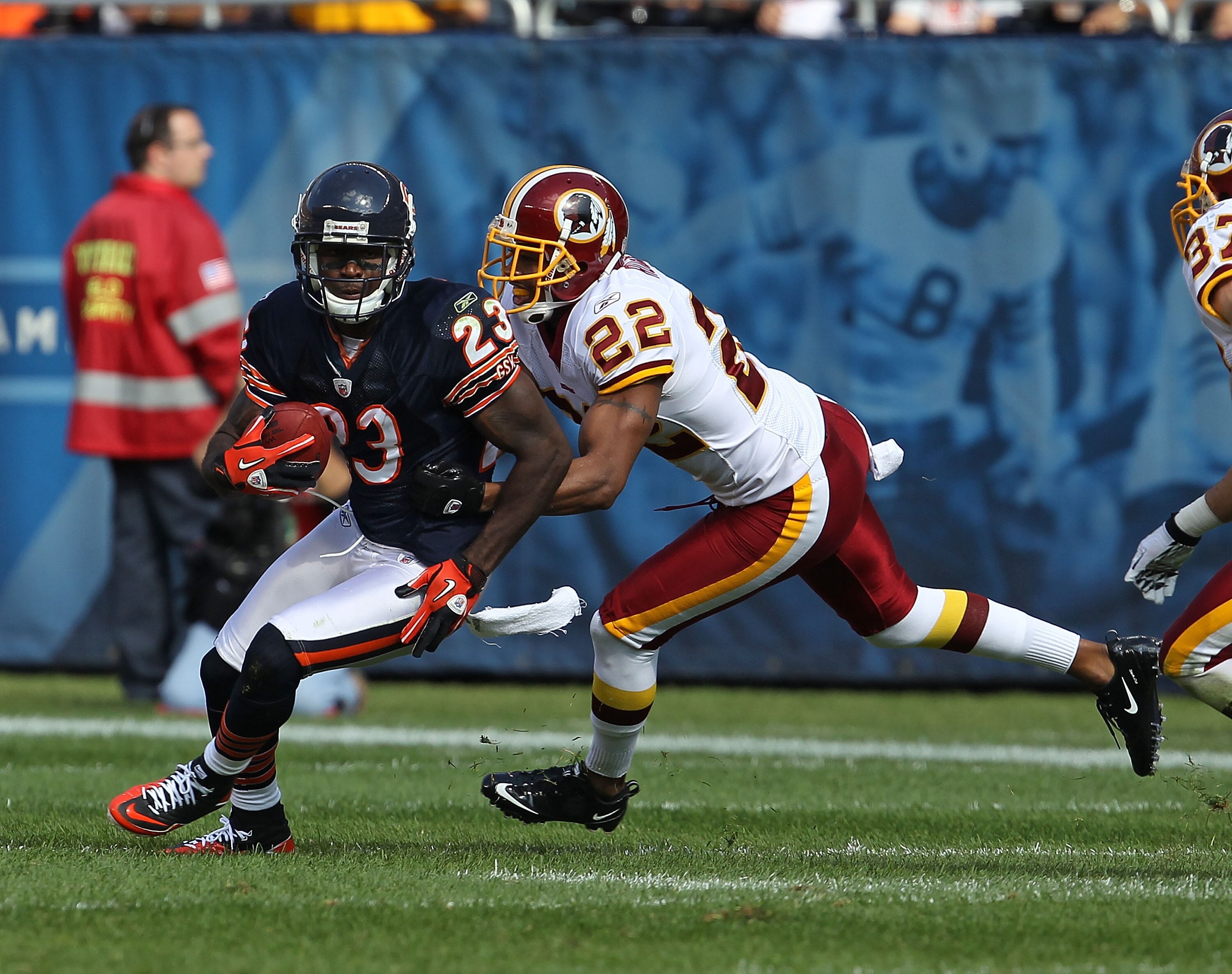 CHICAGO - OCTOBER 24: Devin Hester #23 of the Chicago Bears avoids a tackle attempt by Carlos Rogers #22 of the Washington Redskins at Soldier Field on October 24, 2010 in Chicago, Illinois. The Redskins defeated the Bears 17-14. (Photo by Jonathan Daniel
