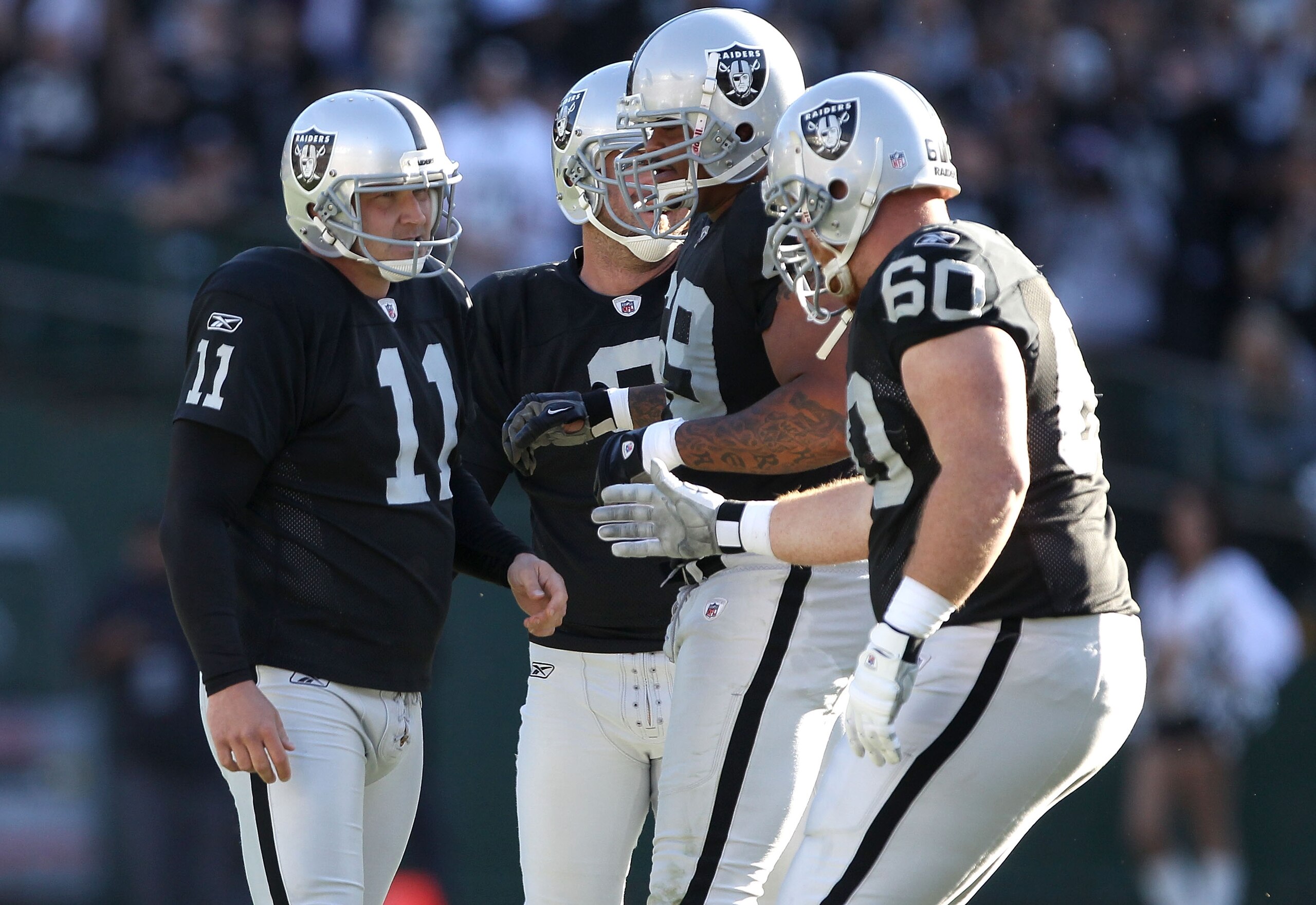 OAKLAND, CA - OCTOBER 31: Sebastian Janikowski #11 of the Oakland Raiders is congratulated by teammates after he kicked a field goal against the Seattle Seahawks at Oakland-Alameda County Coliseum on October 31, 2010 in Oakland, California. (Photo by Ez OAKLAND, CA - OCTOBER 31: Sebastian Janikowski #11 of the Oakland Raiders is congratulated by teammates after he kicked a field goal against the Seattle Seahawks at Oakland-Alameda County Coliseum on October 31, 2010 in Oakland, California. (Photo by Ez