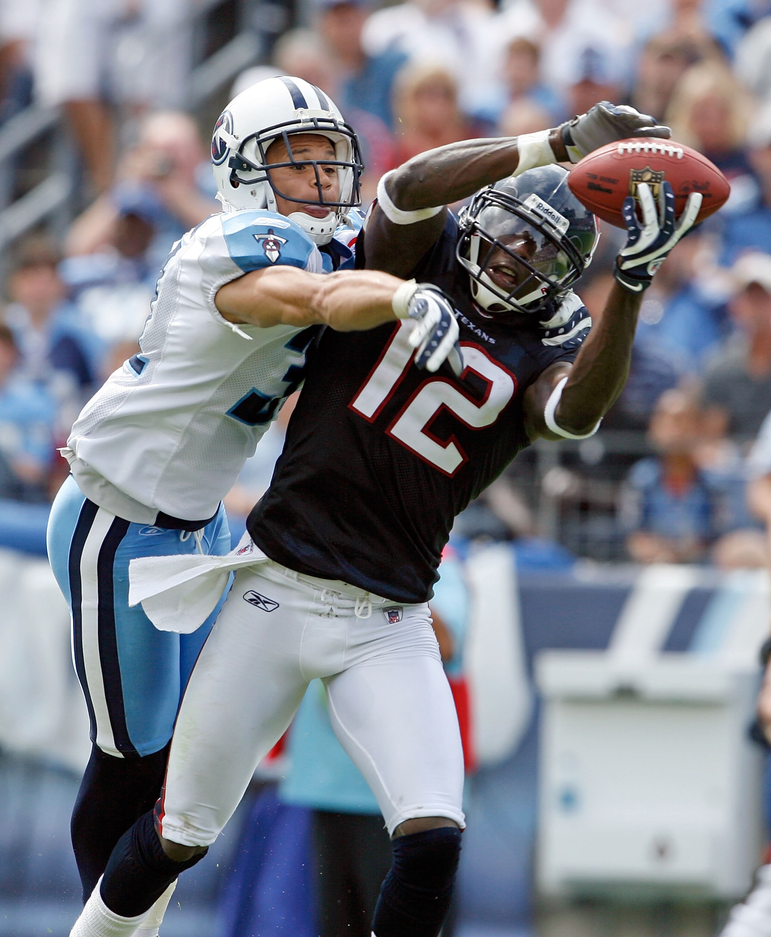 NASHVILLE, TN - SEPTEMBER 20: Jacoby Jones #12 of the Houston Texans catches a touchdown pass while defended by Cortland Finnegan #31 of the Tennessee Titans during the NFL game at LP Field on September 20, 2009 in Nashville, Tennessee. The Texans won 3 NASHVILLE, TN - SEPTEMBER 20: Jacoby Jones #12 of the Houston Texans catches a touchdown pass while defended by Cortland Finnegan #31 of the Tennessee Titans during the NFL game at LP Field on September 20, 2009 in Nashville, Tennessee. The Texans won 3